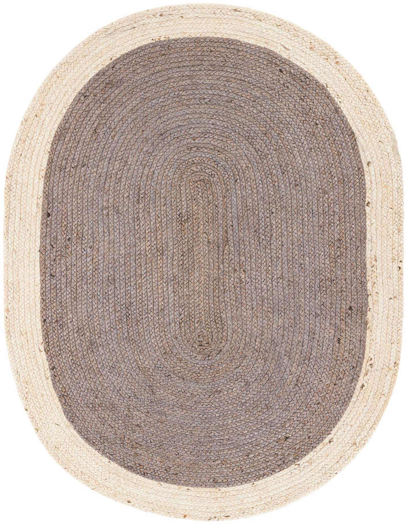 An oval 4' 1 x 6' 1 gray and white braided jute rug with a modern, natural style.