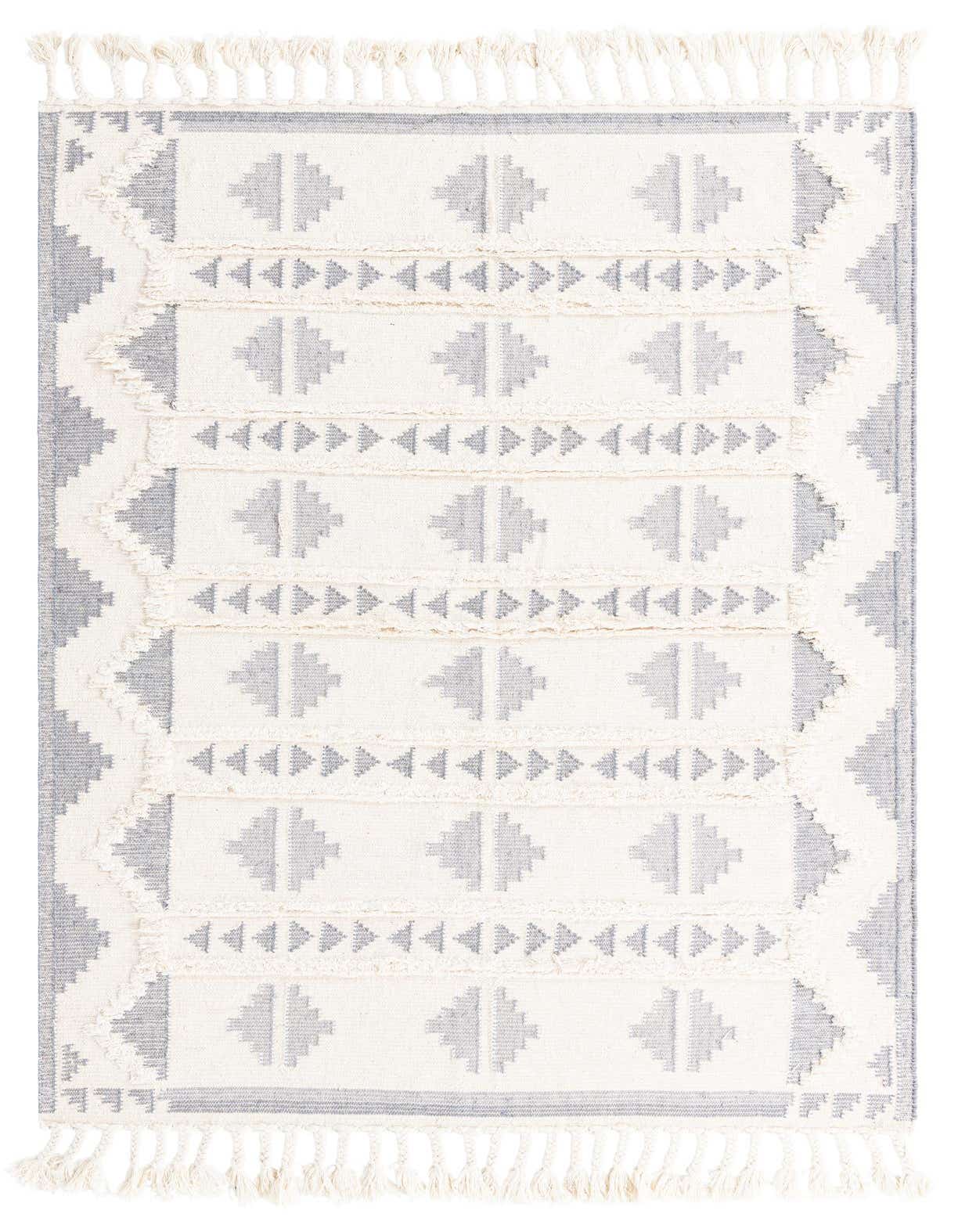 A 6x9 rectangular tribal shag rug in grays and whites, featuring geometric patterns and fringe.