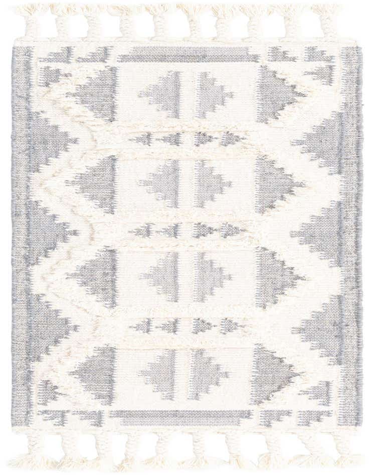 A 5 ft runner rug in gray and white, featuring a tribal pattern with shag texture and braided tassels.