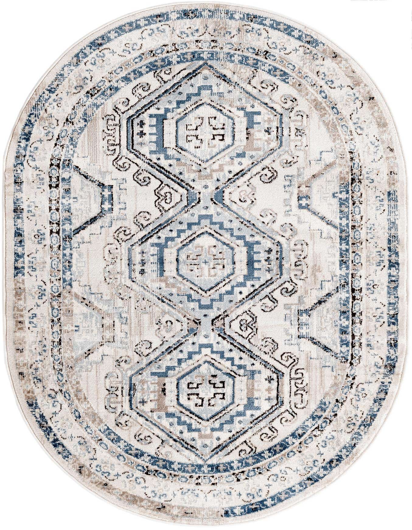 An oval 4'x6' Rugs.com Charlotte rug featuring a faded traditional tribal pattern in blues, grays, and white.