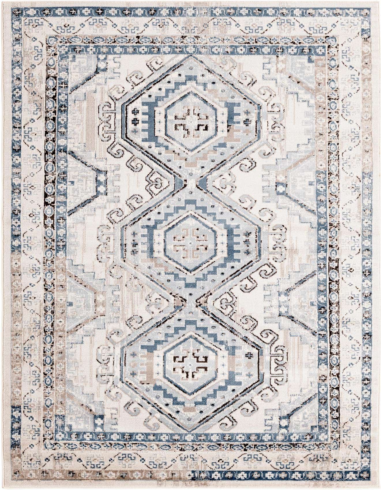 A 5x8 rectangular Charlotte rug in blues and grays with a traditional tribal pattern, suitable for a living room.