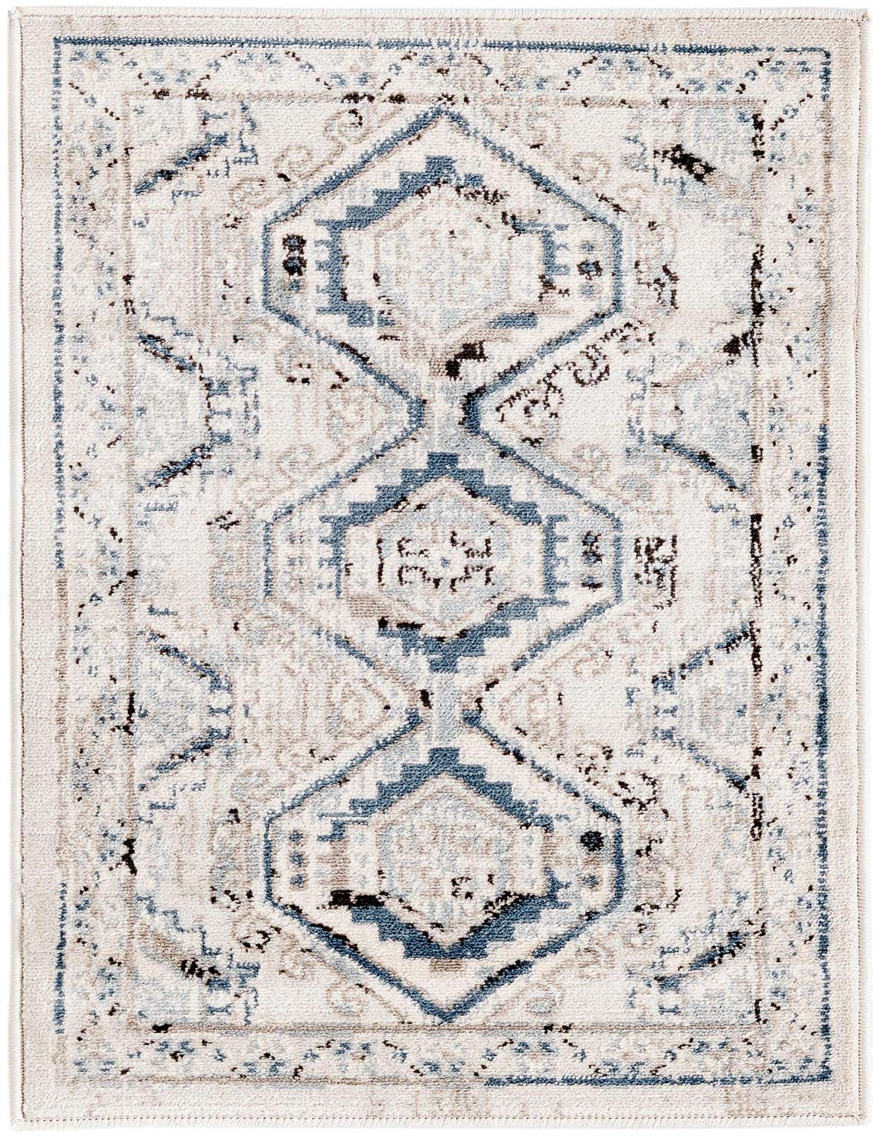A 2x3 rectangular Charlotte rug with a distressed traditional tribal pattern in blues, grays, and cream.