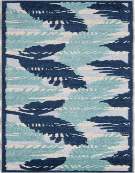 A 10 ft runner rug featuring a modern tropical botanical pattern in shades of deep blue, light blue, and cream on a gray background, ideal for a hallway or patio.