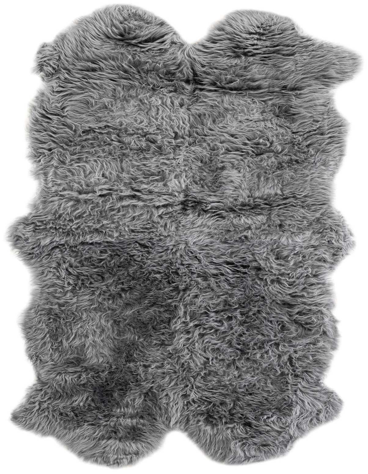 A luxurious 3' 3 x 6' 0 freeform gray lambskin rug with a textured, medium pile, perfect for adding warmth to an indoor space.