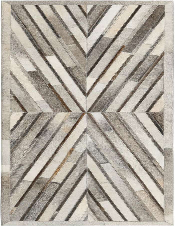 A 6 ft runner rug with a modern abstract pattern made from patches of ivory, cream, gray, and silver cowhide and leather.