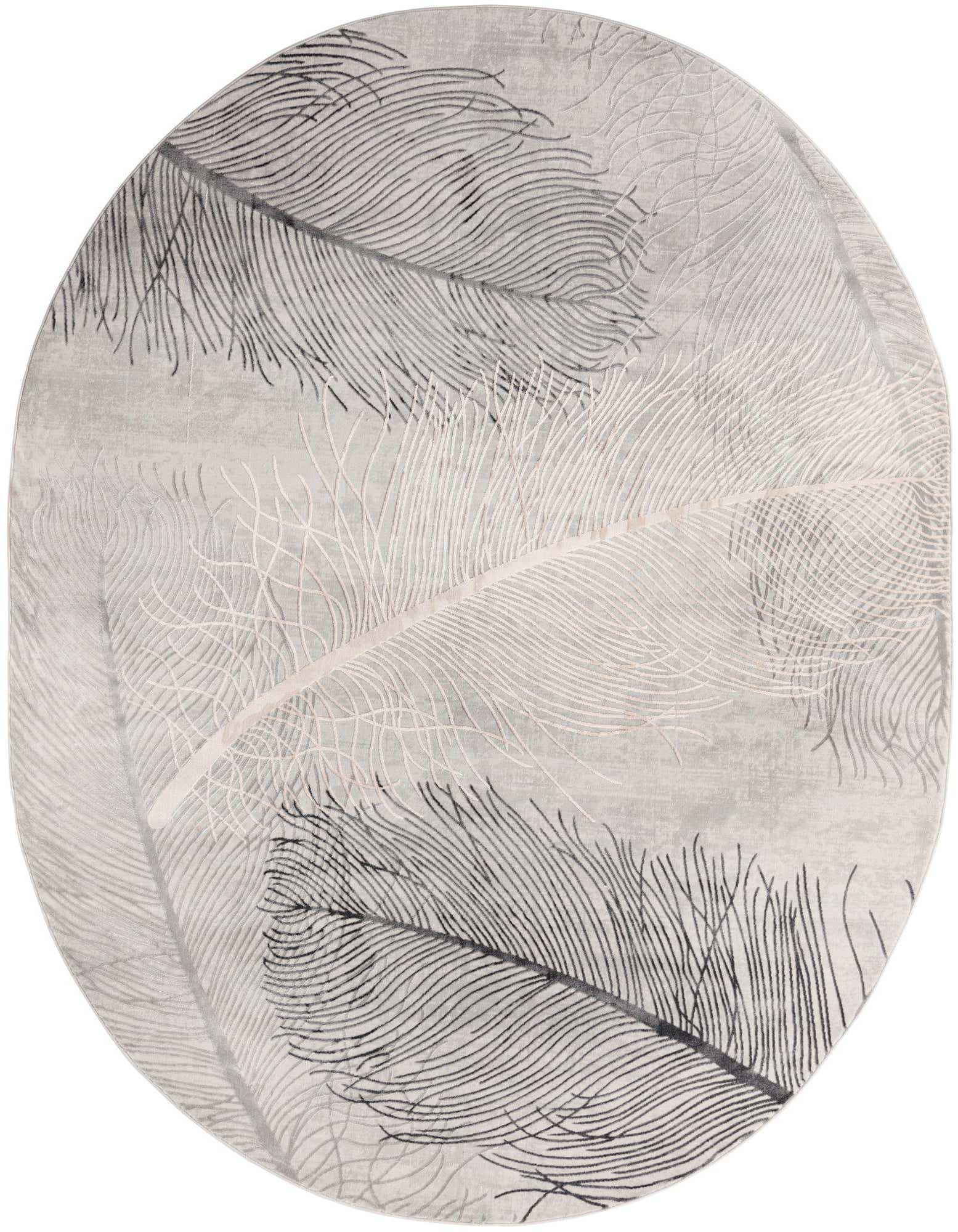 An oval gray rug with a modern tropical feather pattern in varying shades of gray and silver, featuring a high/low textured pile.