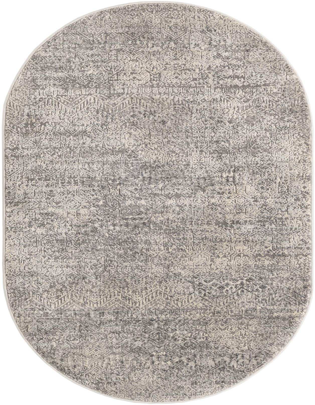 An oval 3' 3 x 5' 3 gray area rug with a distressed, abstract pattern, suitable for an indoor living space.
