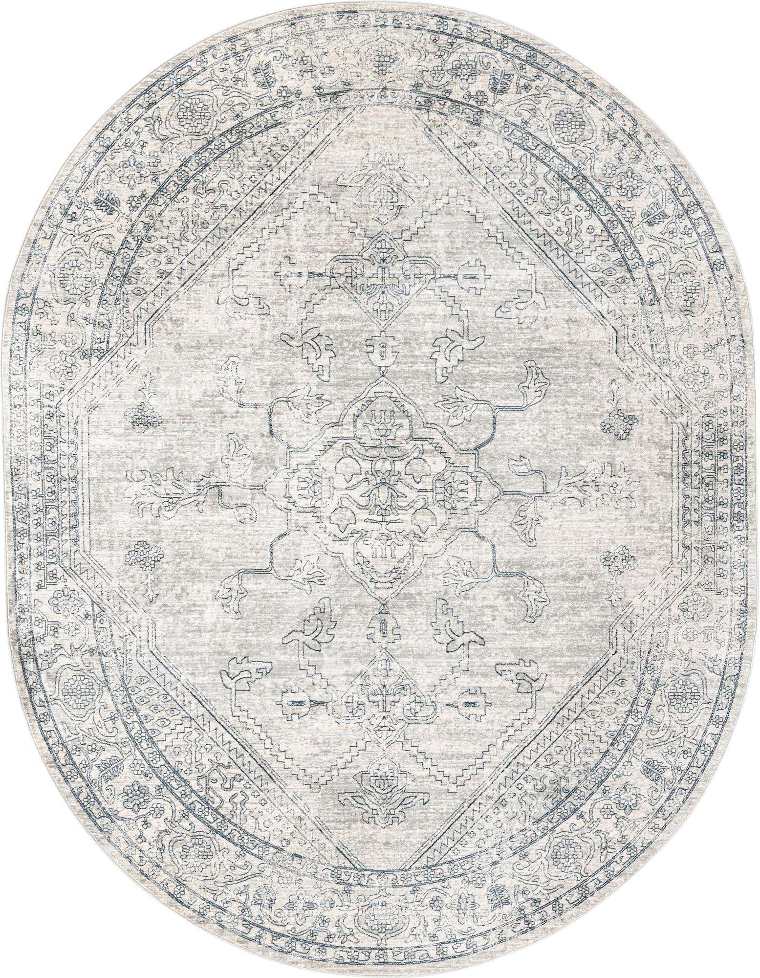 An oval 7' 10 x 10' 2 gray area rug with a faded traditional medallion and tribal pattern, ideal for an indoor living space.