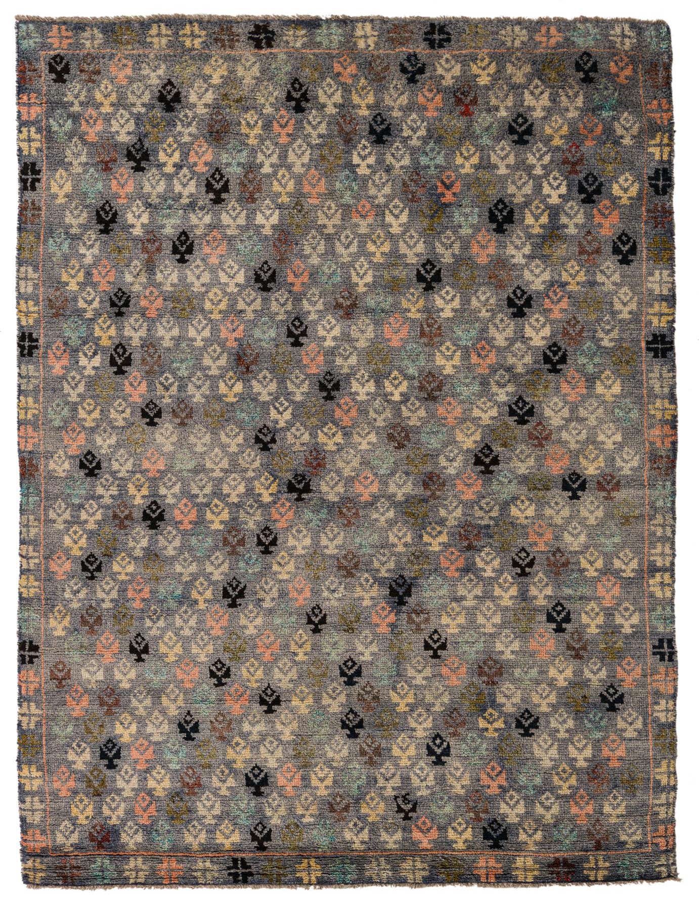 A 5x8 rectangular gray wool rug with a repeating tribal pattern in various pastel colors and black, suitable for a living room.