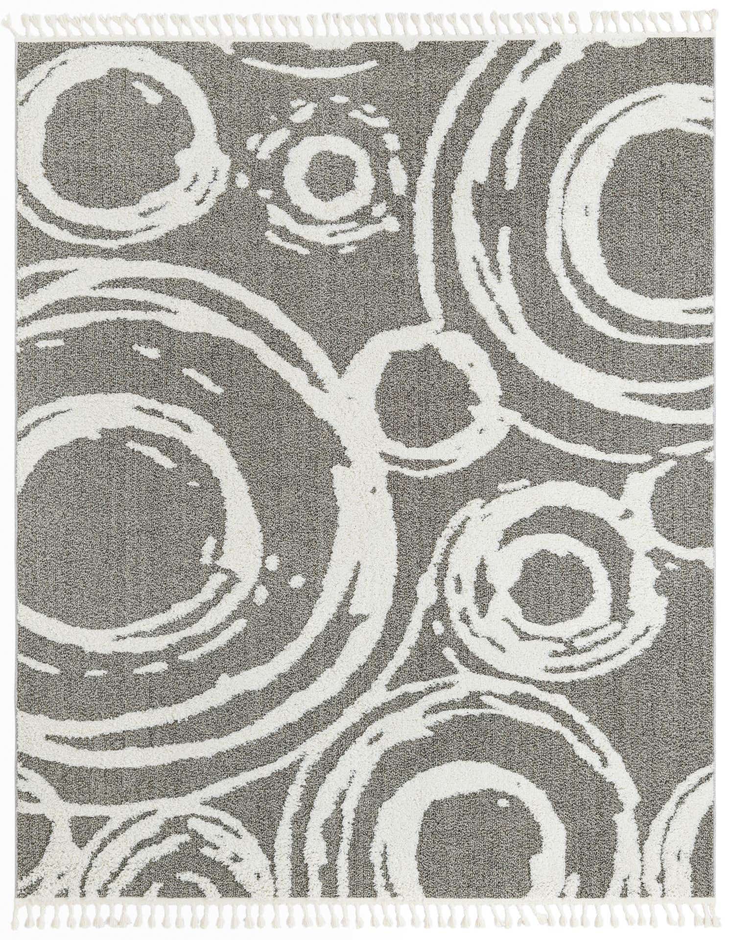 A rectangular 8x10 gray area rug with a modern abstract pattern of large, textured white circles and smaller rings, featuring white fringe.