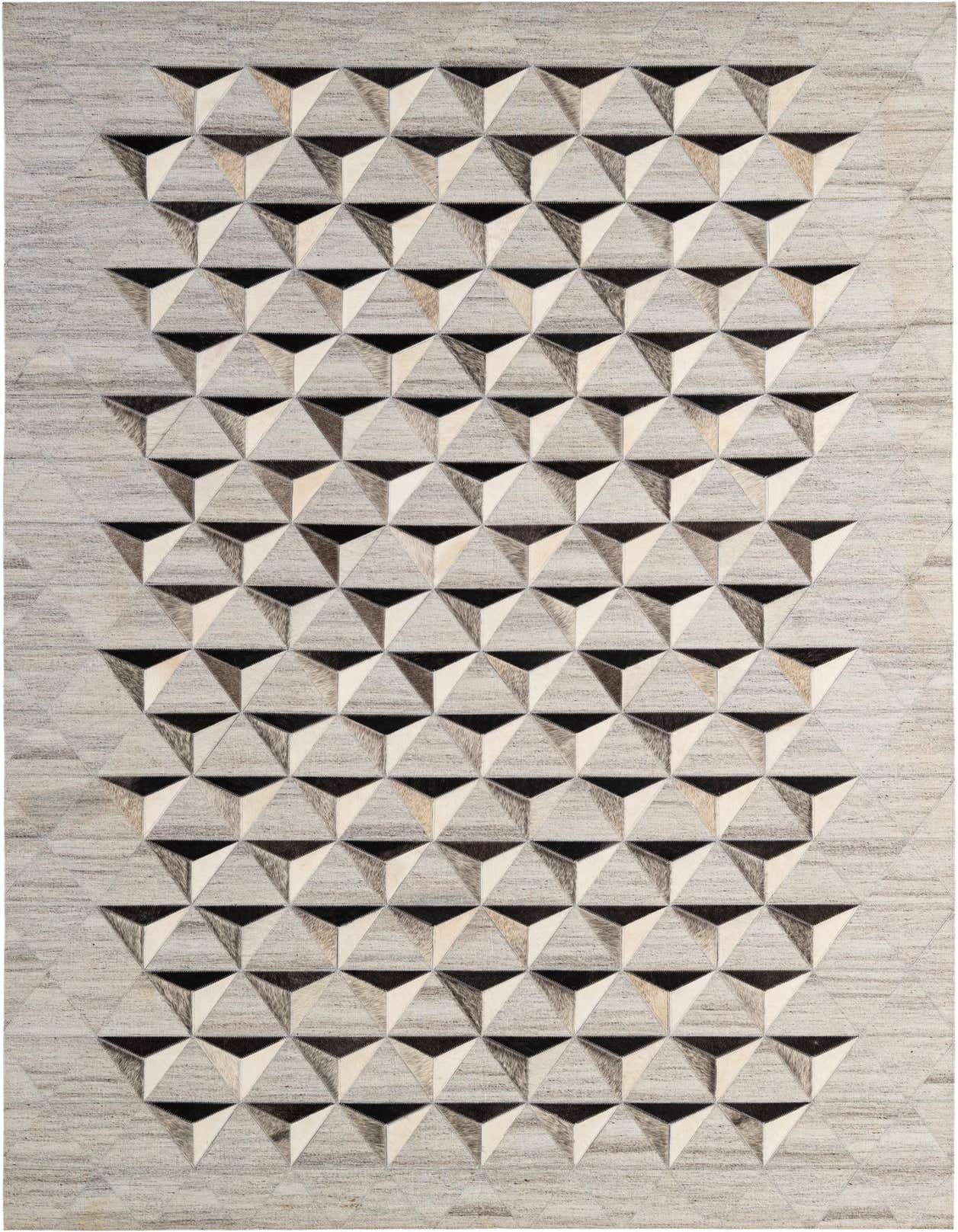 A 5x8 rectangular Cowhide - Patchwork rug featuring a modern geometric pattern of gray, silver, and black triangular shapes.