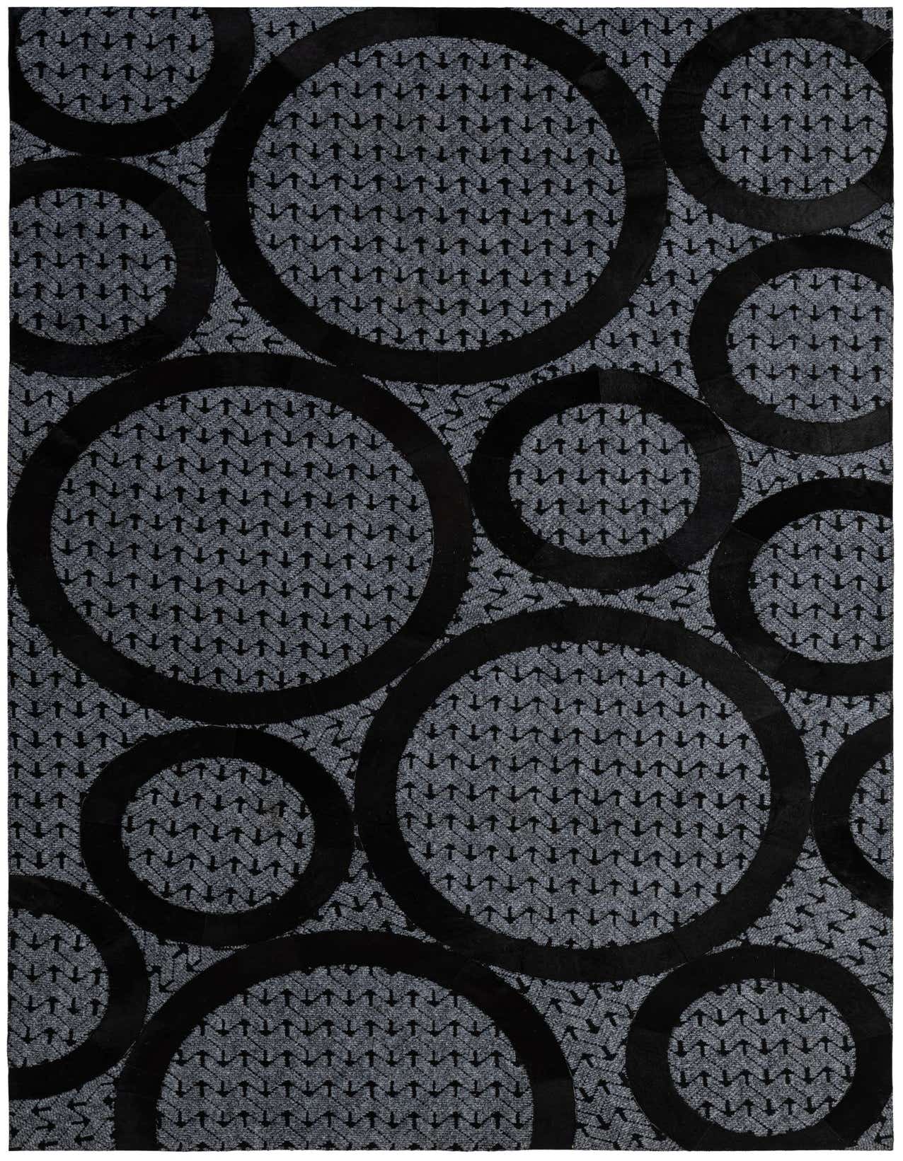 A 5x8 rectangular gray cowhide rug with large, overlapping black abstract circles and a subtle arrow pattern.