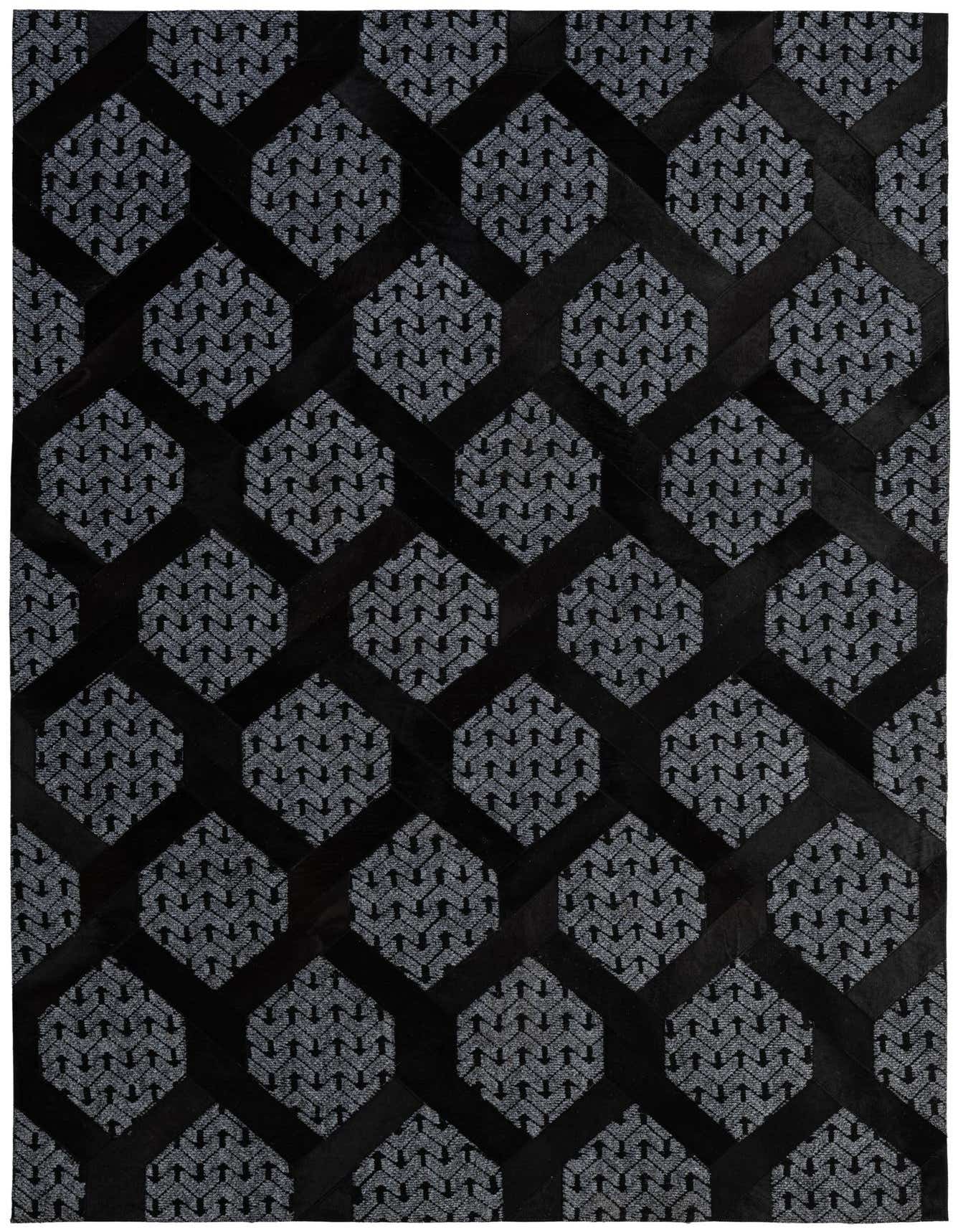 A 5x8 rectangular gray and black cowhide rug with a modern geometric pattern, ideal for a living room.