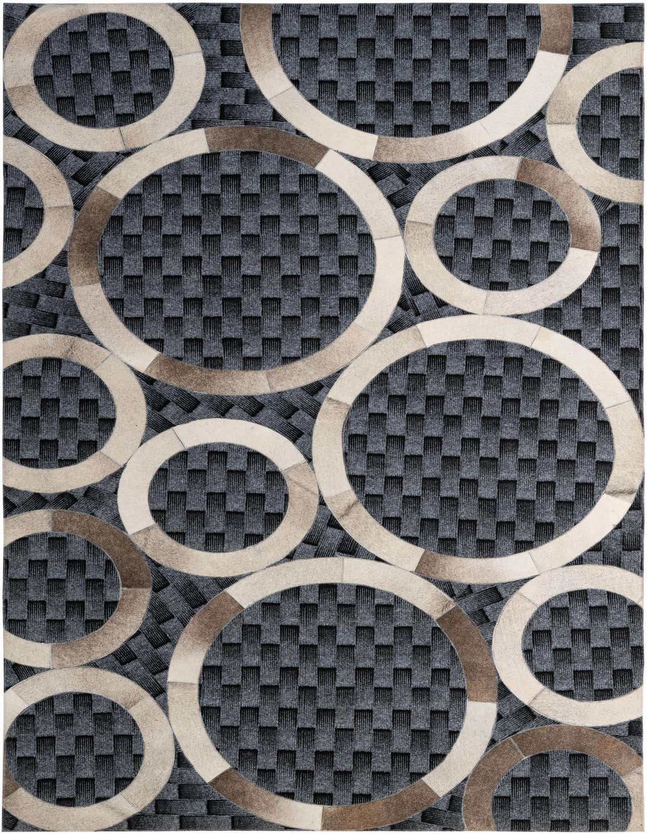 A 5x8 rectangular gray modern area rug featuring an abstract pattern of overlapping circles in varying shades of brown and cream cowhide, set against a textured dark gray and black woven background.