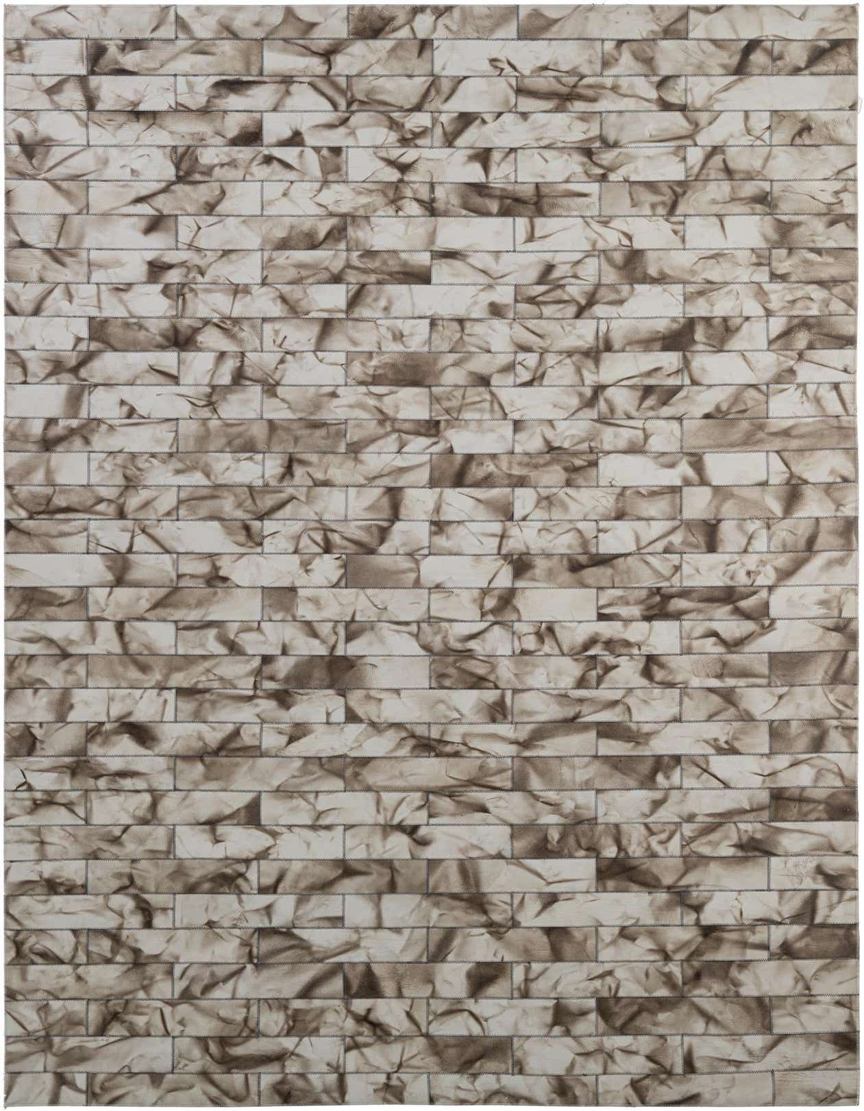 A 5x8 rectangular Cowhide - Patchwork rug in shades of gray and silver, featuring a modern, abstract brick-like pattern with visible stitching.