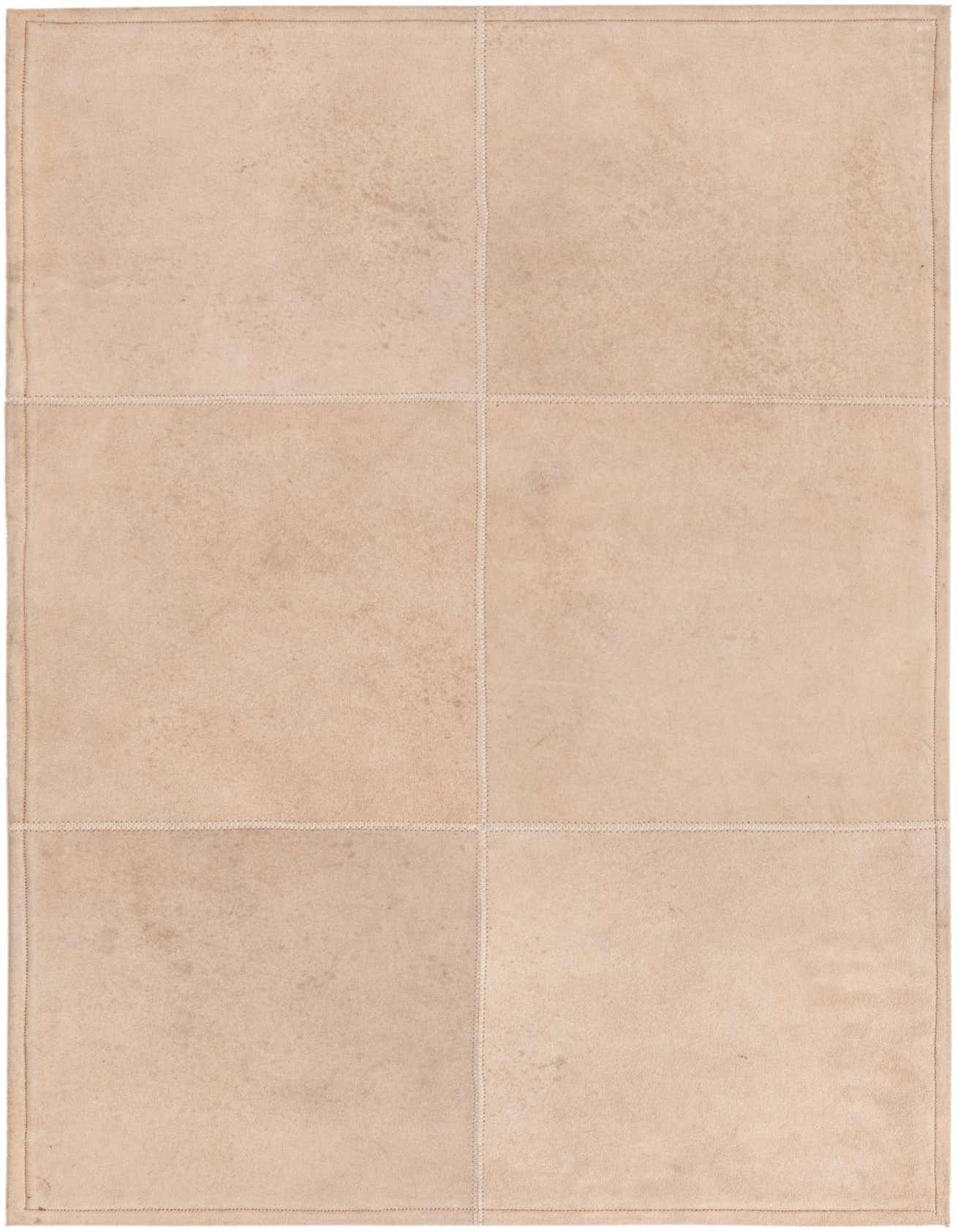 A 2x3 rectangular modern rug made from gray cowhide and leather, featuring a patchwork design.