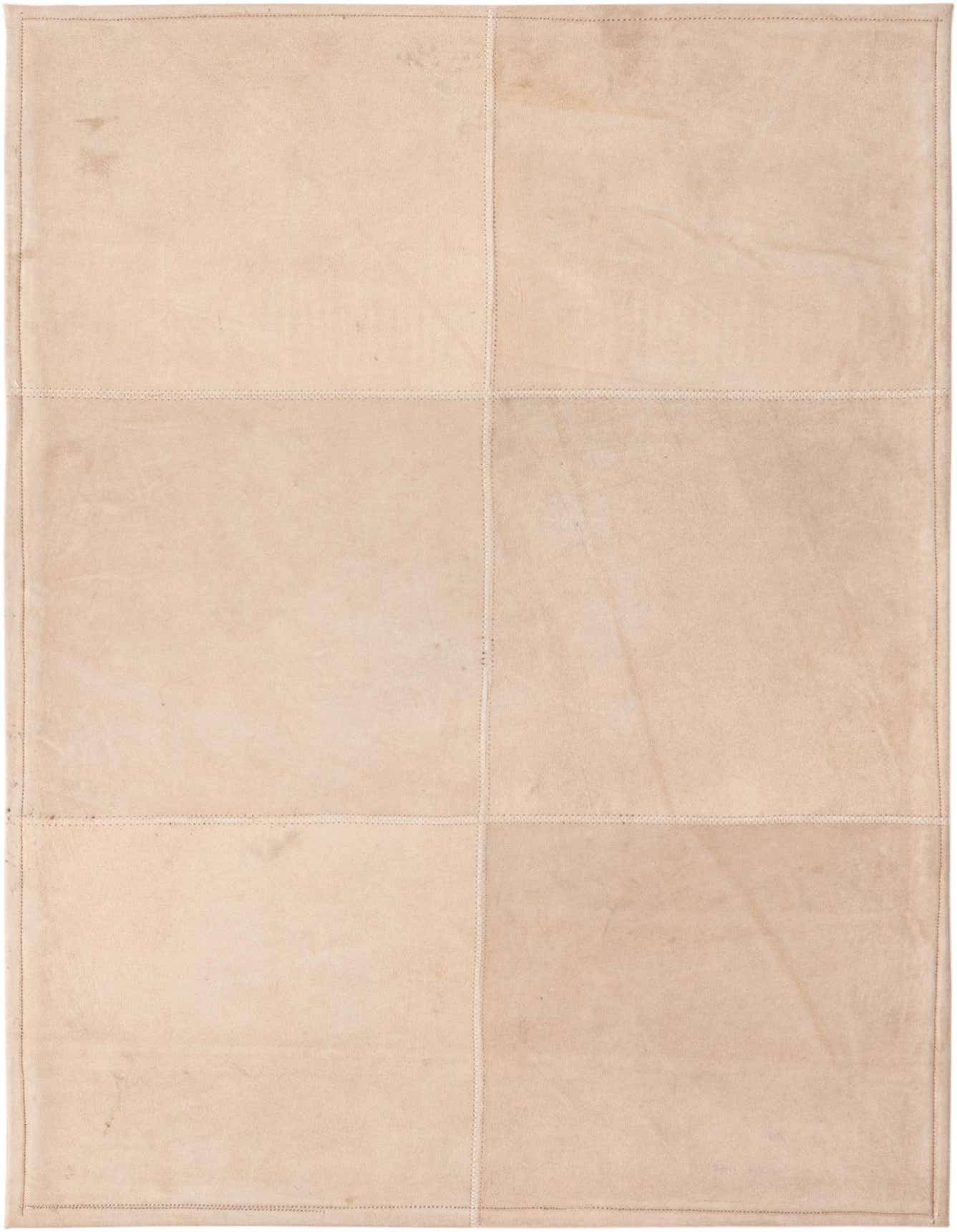 A 2x3 rectangular modern rug made from gray cowhide and leather, featuring a patchwork design with visible stitching.