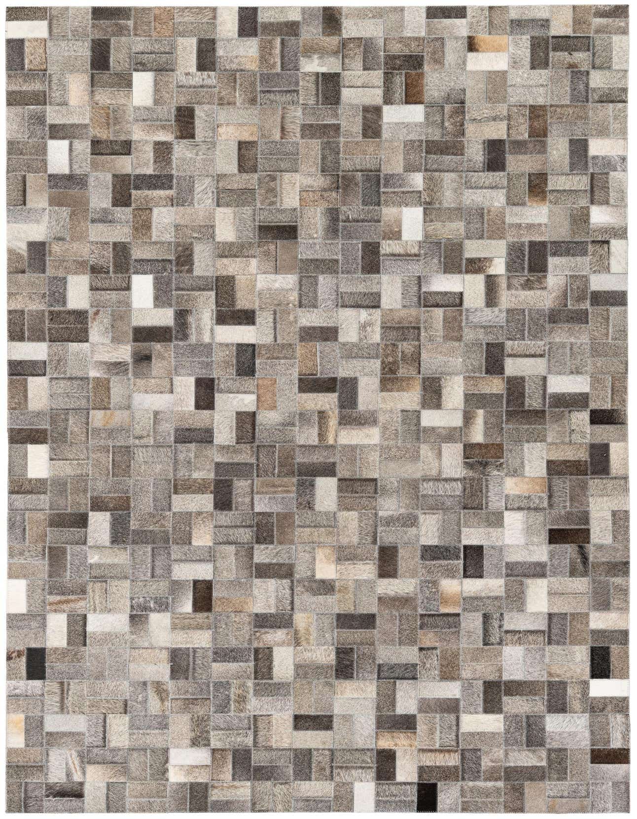 A 5x8 rectangular Cowhide Stocks rug in varying shades of gray, silver, and brown, featuring a modern patchwork design.