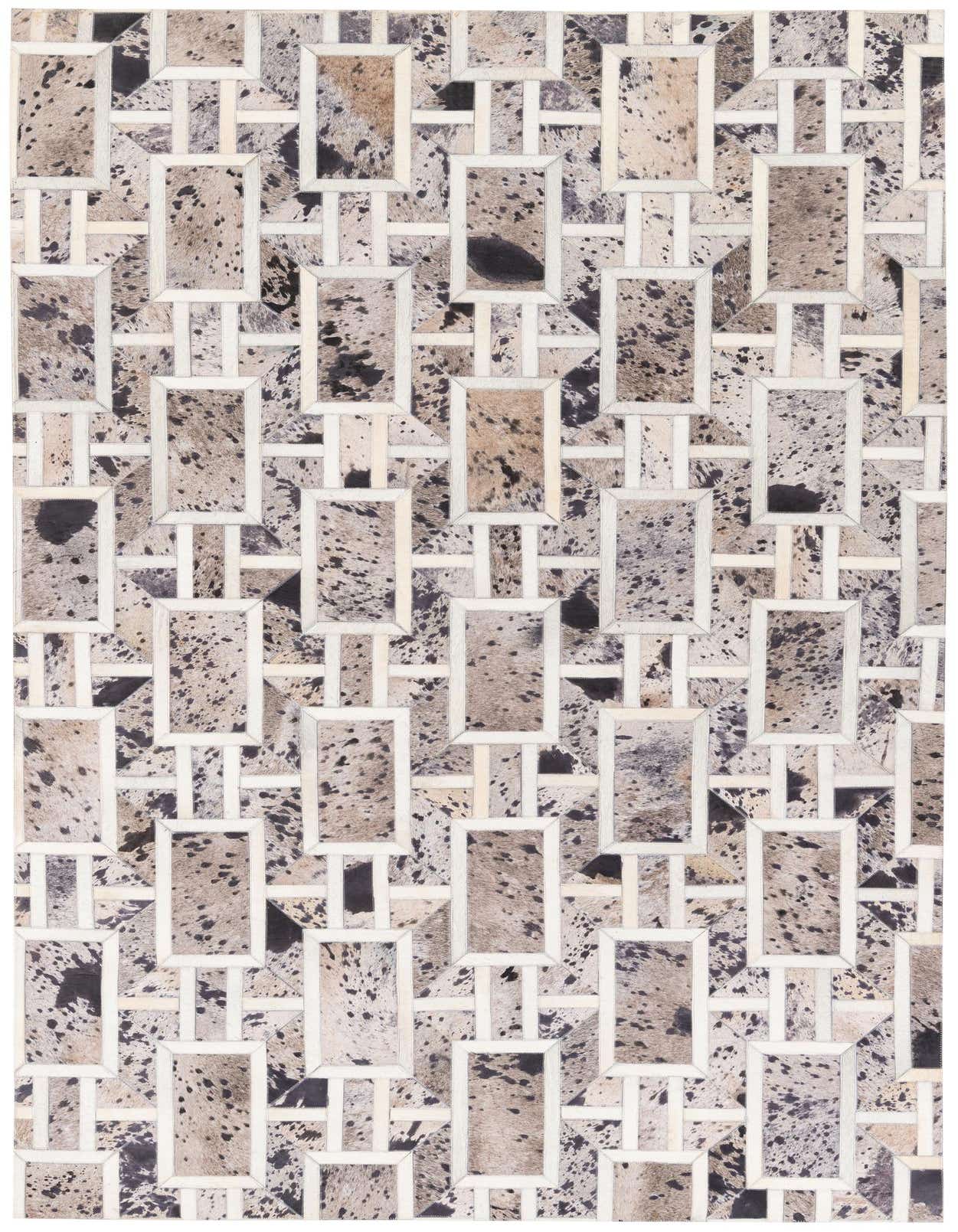 A rectangular 5x8 gray patchwork cowhide rug with a geometric pattern, featuring varying shades of gray, black, and white.