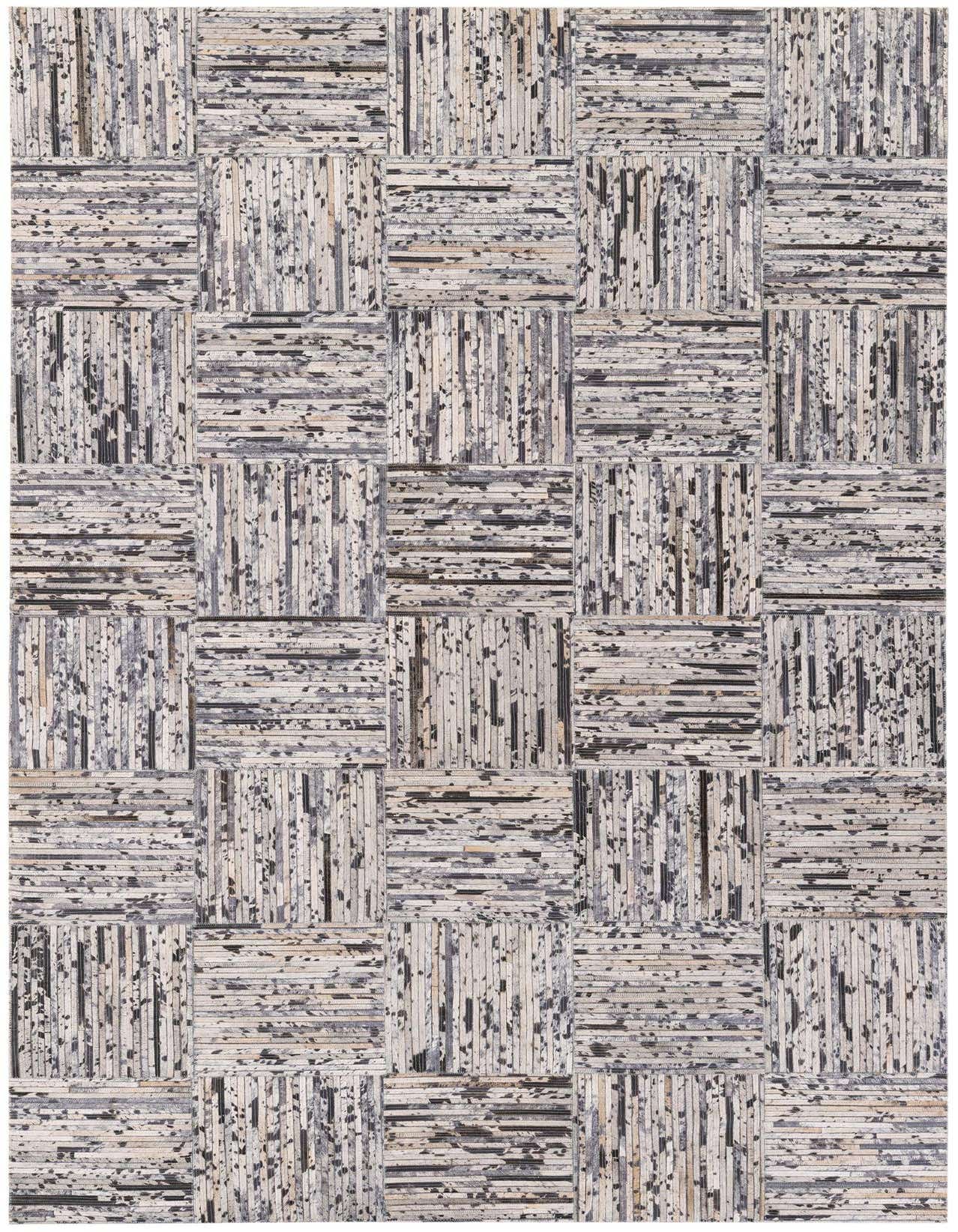 A 5x8 rectangular Cowhide Stocks rug from Rugs.com, featuring a modern patchwork pattern of varying gray and silver cowhide strips, ideal for a living room.