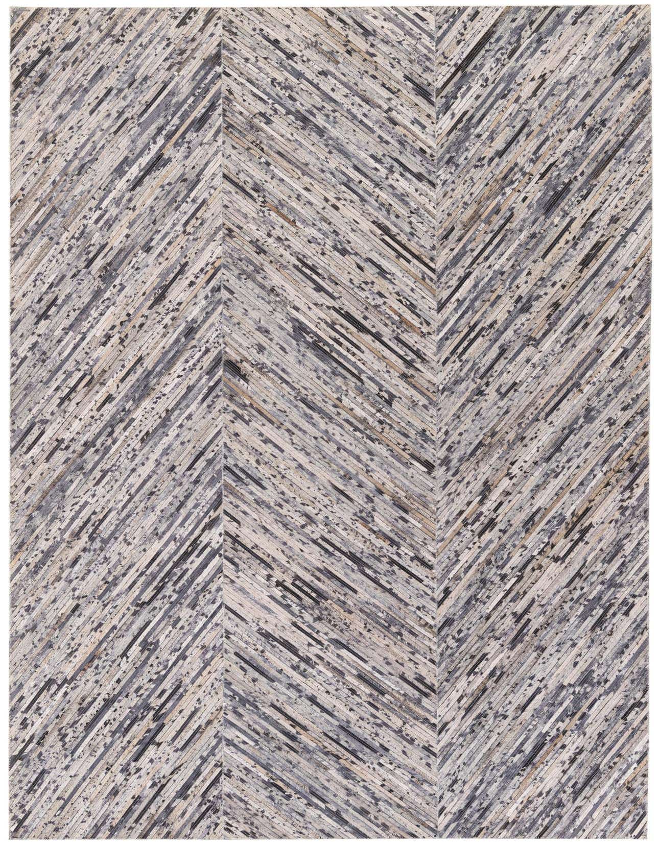 A 5x8 rectangular Cowhide & Leather rug featuring a modern chevron pattern in various shades of gray and silver.