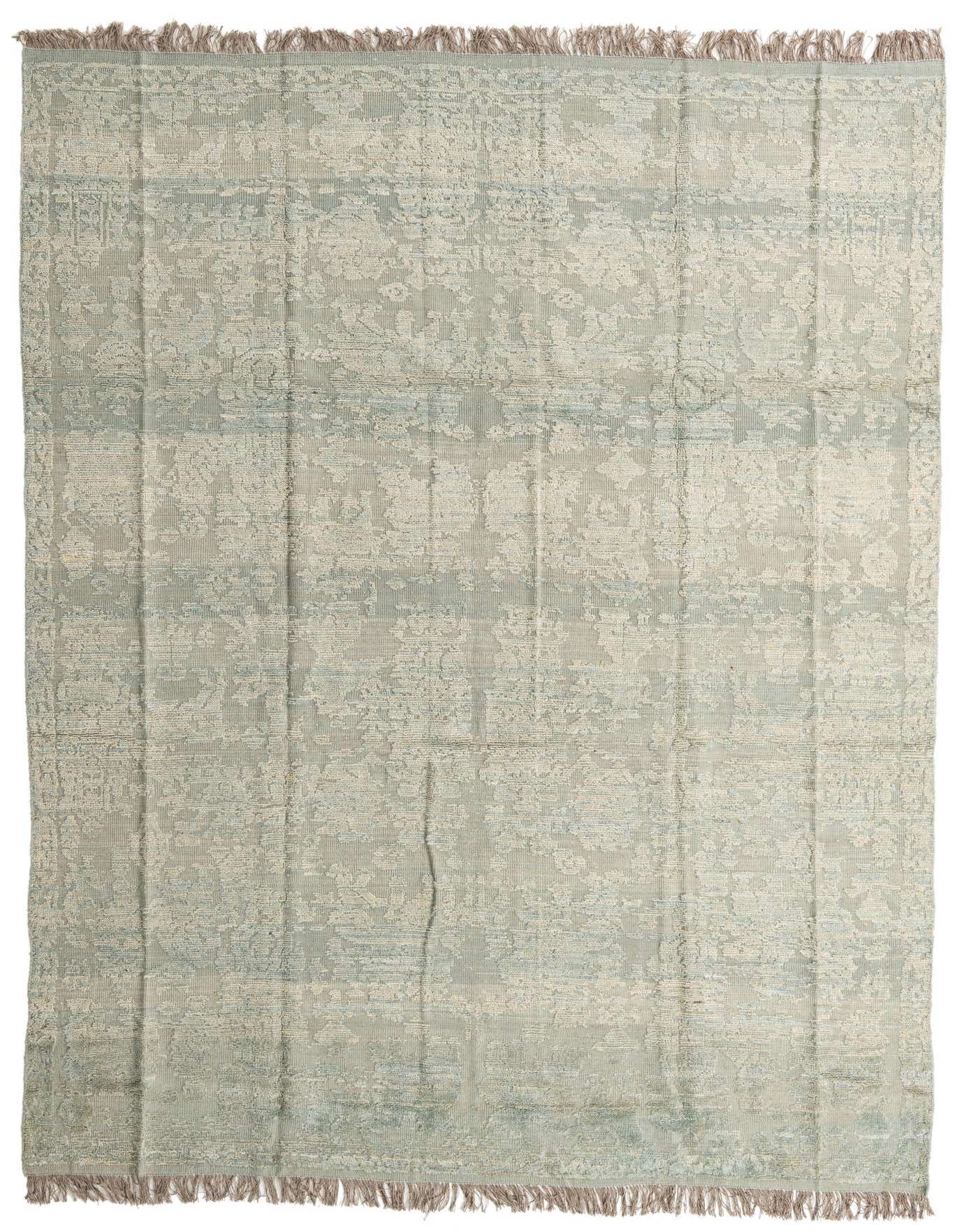 A 9x12 rectangular gray wool rug with a modern abstract pattern and fringed ends, suitable for a living room.