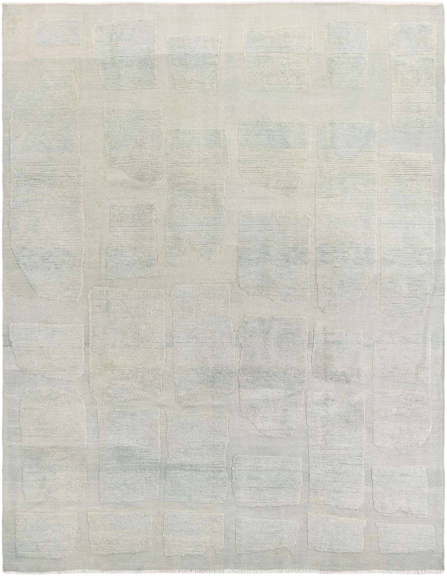 A rectangular 8x10 gray wool rug with a modern abstract pattern of raised, textured rectangular and curved shapes.