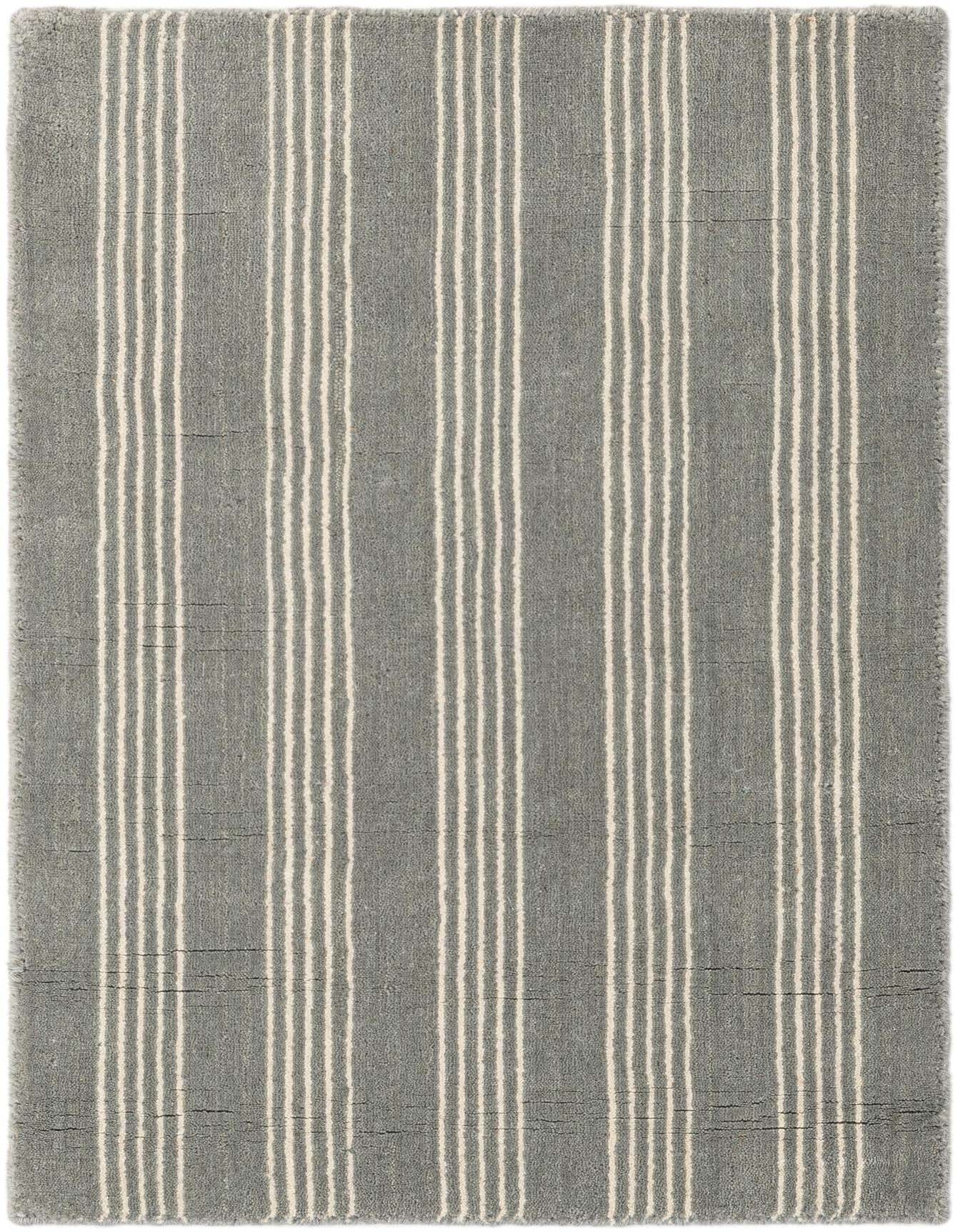 A 2x3 rectangular Jill Zarin Natural Wool rug with a modern gray background and thin white vertical stripes.