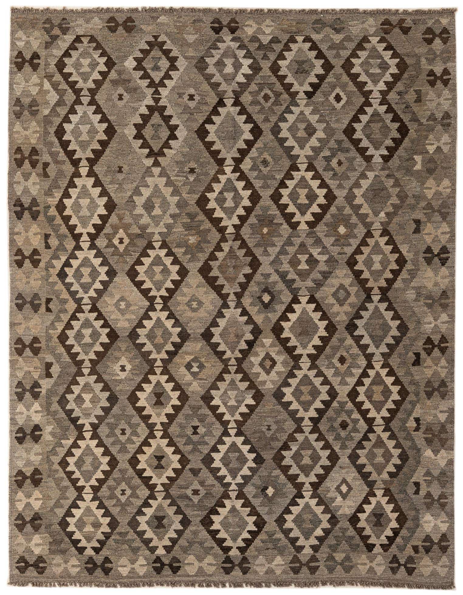 A 7x10 rectangular flatweave rug with a tribal geometric diamond pattern in shades of gray, silver, and brown.