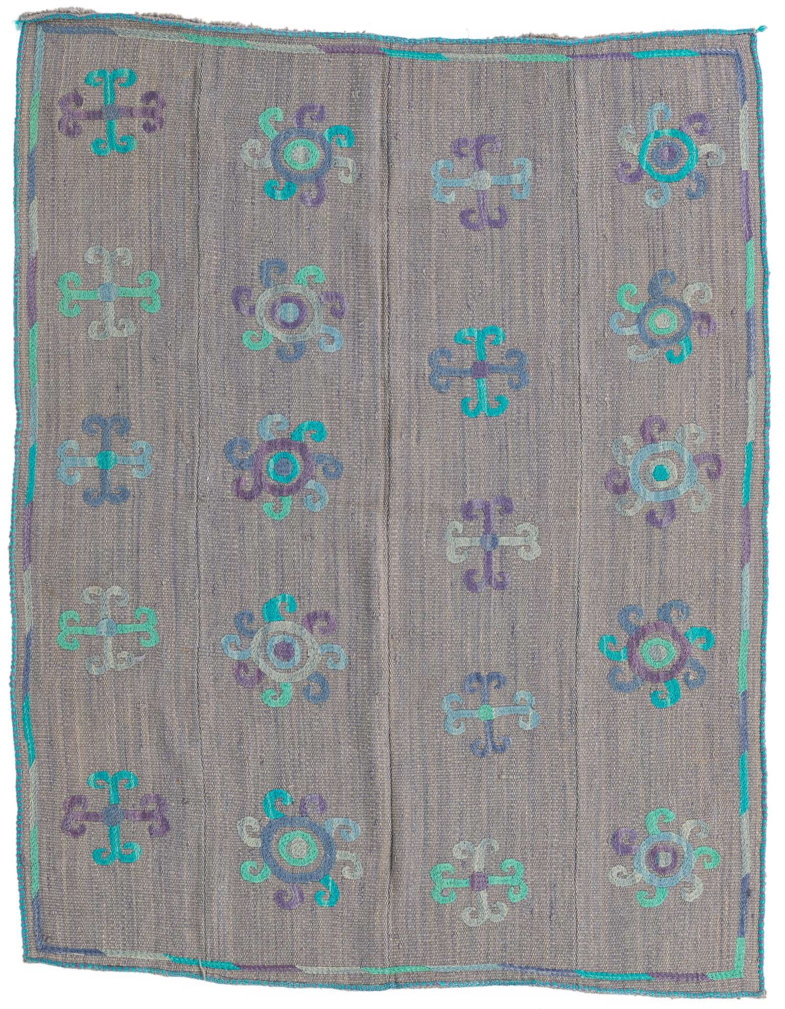 A 4x6 rectangular gray flatweave rug with a tribal pattern of teal and purple medallions and cross shapes.