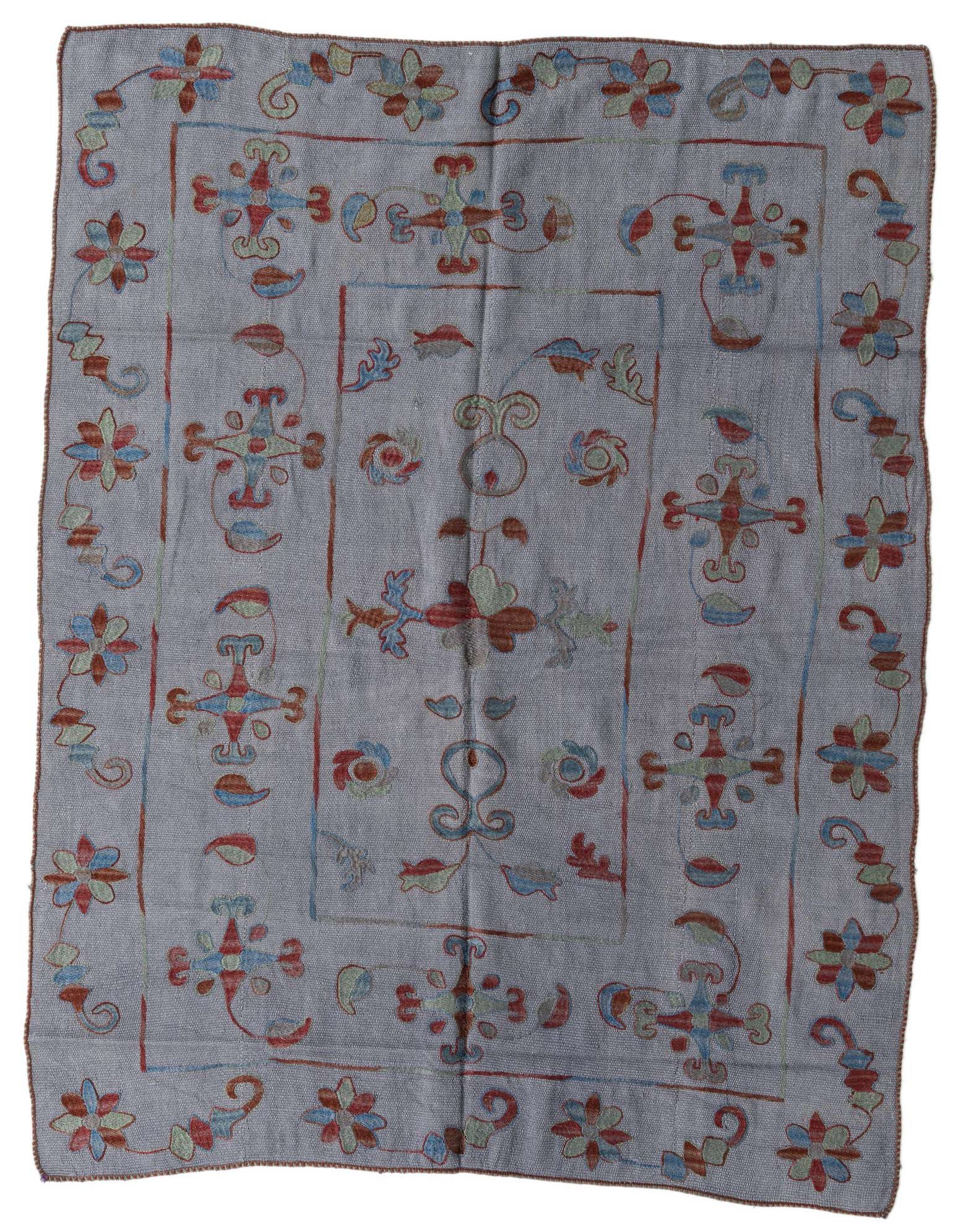 A 4x6 rectangular gray flatweave rug with a colorful tribal floral pattern in red, blue, and green hues.