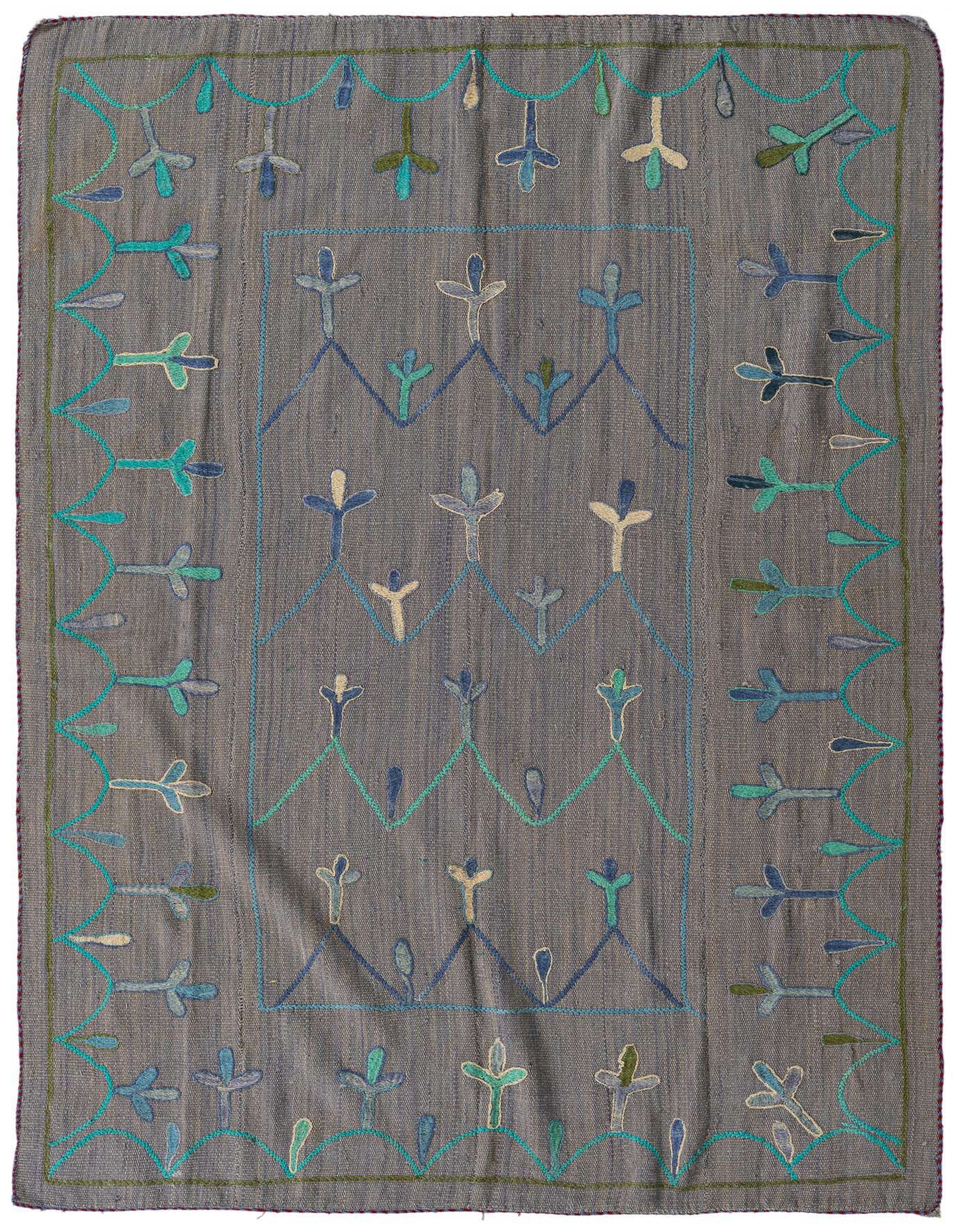 A 4x6 rectangular gray flatweave rug with a tribal pattern of blue, teal, and cream leaf-like motifs.