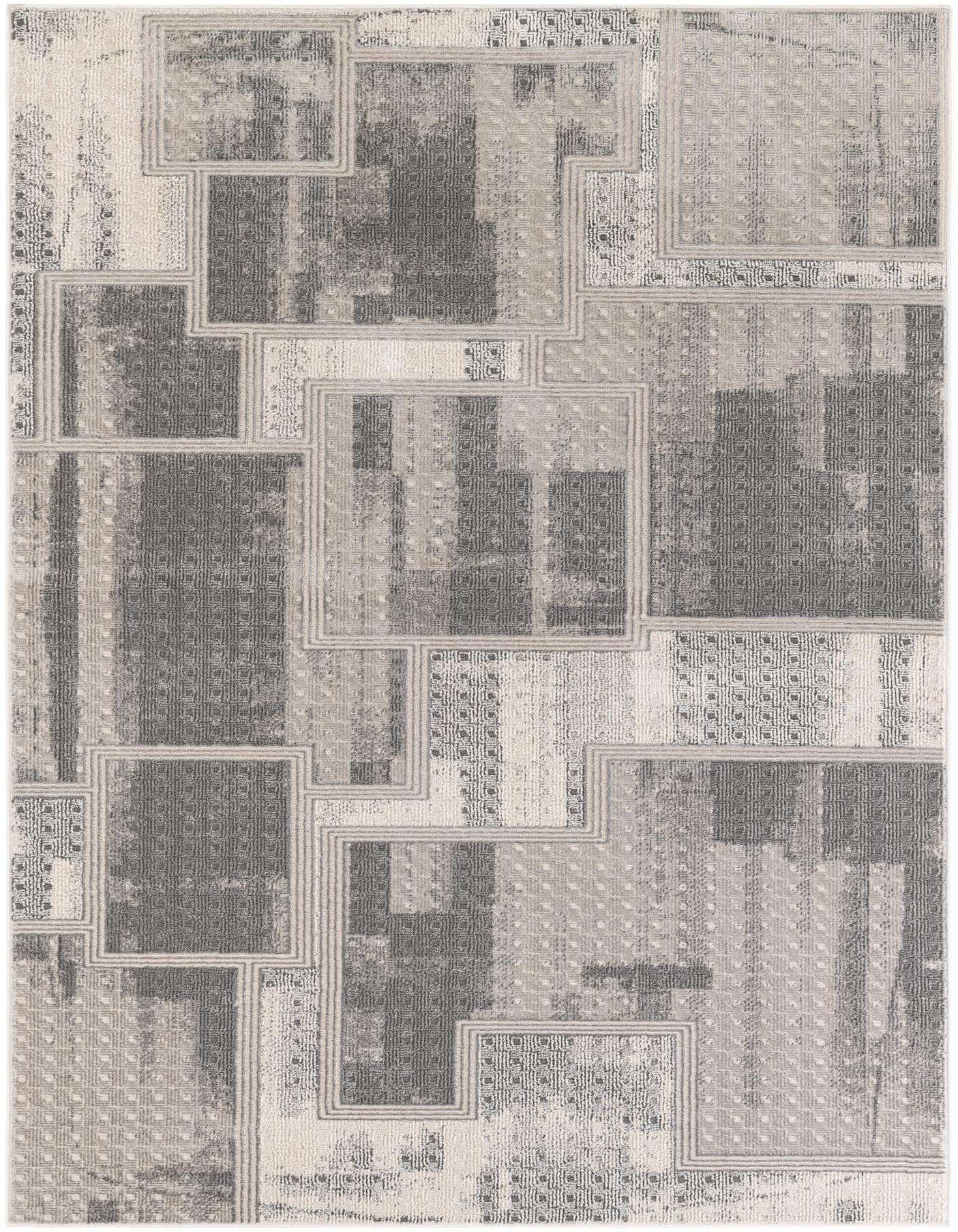 A 5x7 rectangular modern area rug featuring a patchwork design in various shades of gray and silver with textured patterns.