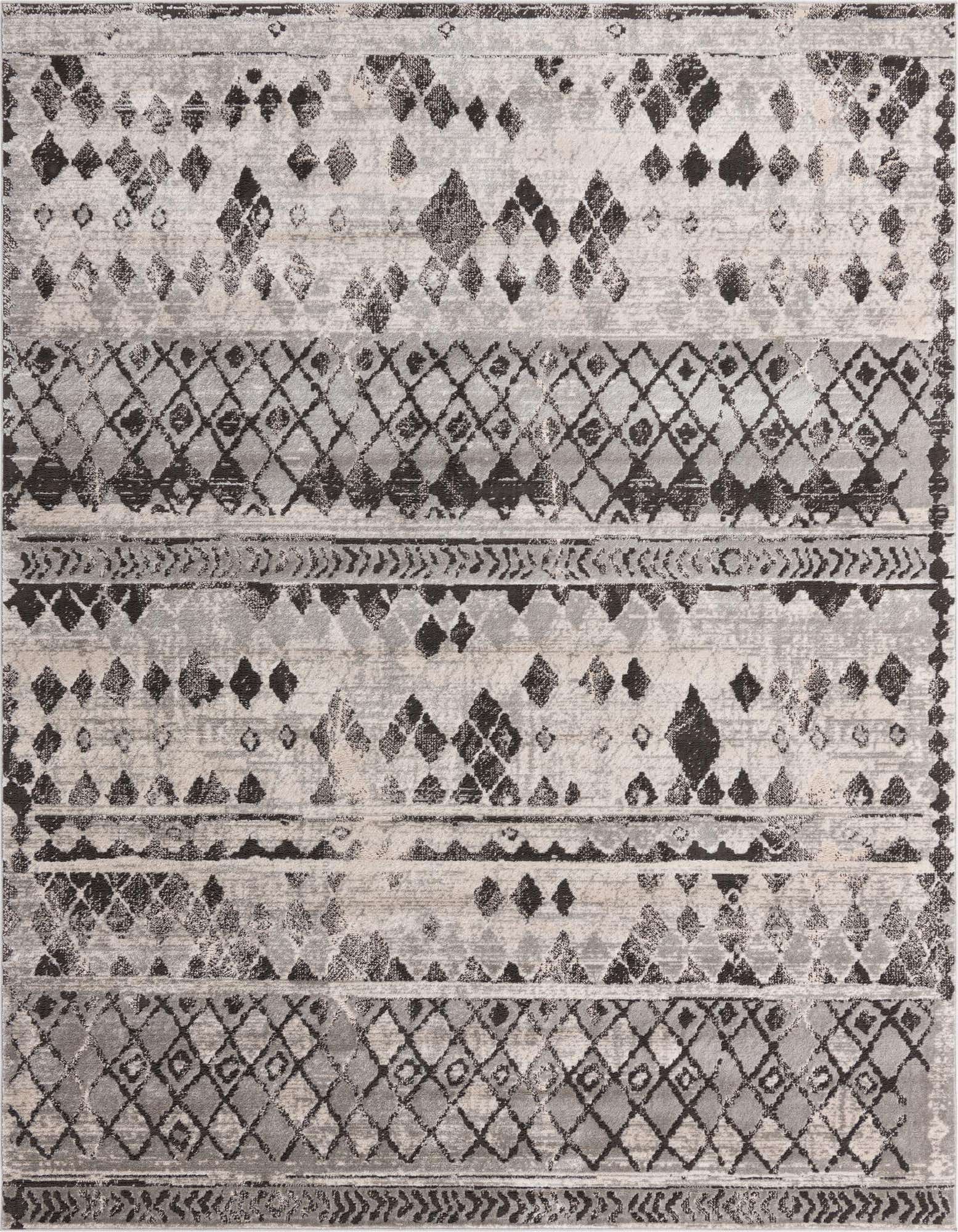 An 8x10 rectangular Rugs.com Leipzig area rug featuring a distressed Southwestern and tribal pattern in various shades of gray and silver.