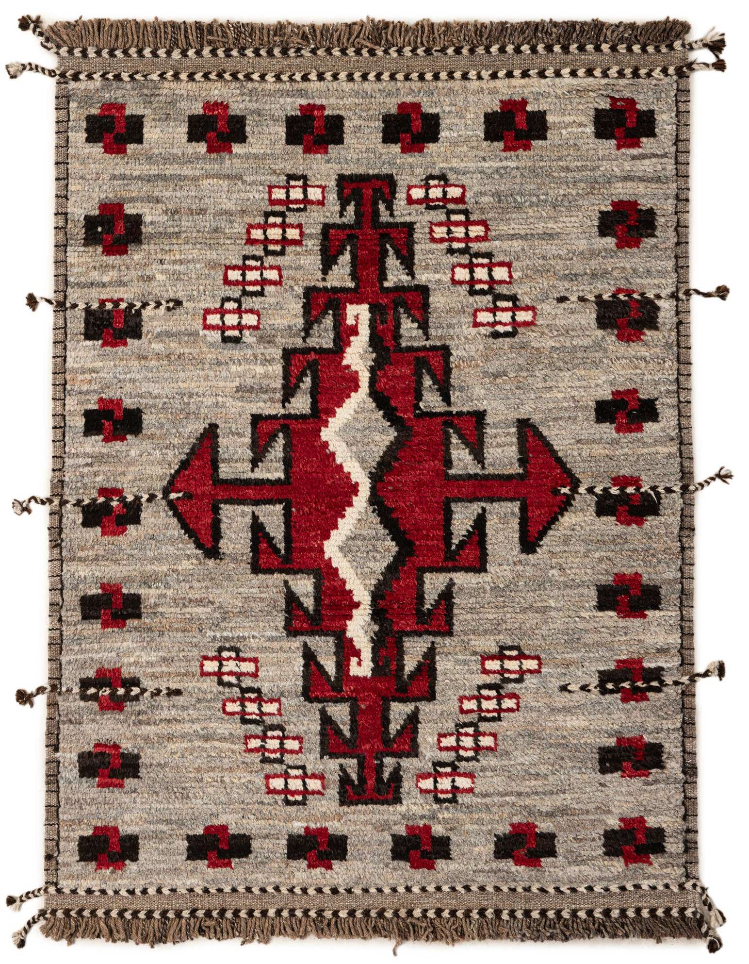 A 4x6 rectangular gray wool shag rug with a bold red, black, and white tribal pattern, handmade for indoor spaces.