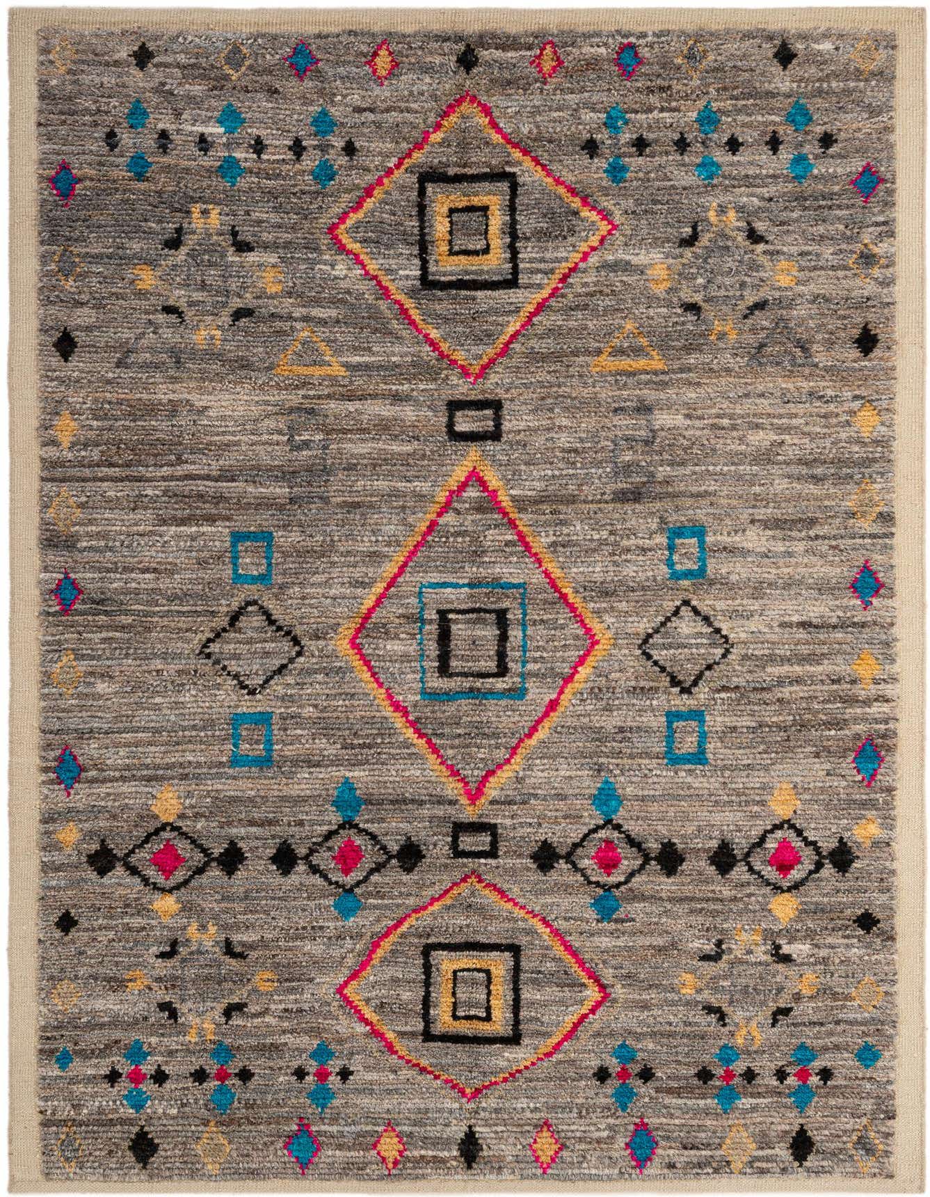 A 5x8 rectangular gray wool rug with a vibrant tribal pattern featuring large pink, yellow, and black diamonds, and smaller blue and black geometric shapes.