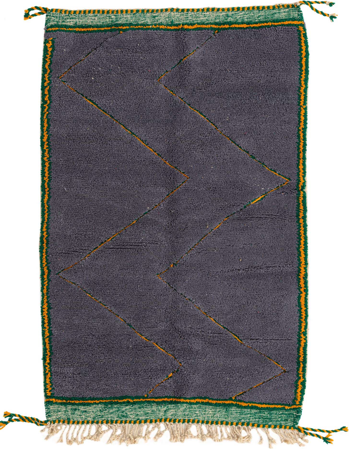 A 4x6 rectangular gray shag rug with an orange zigzag pattern and green and orange striped borders, featuring tassels.