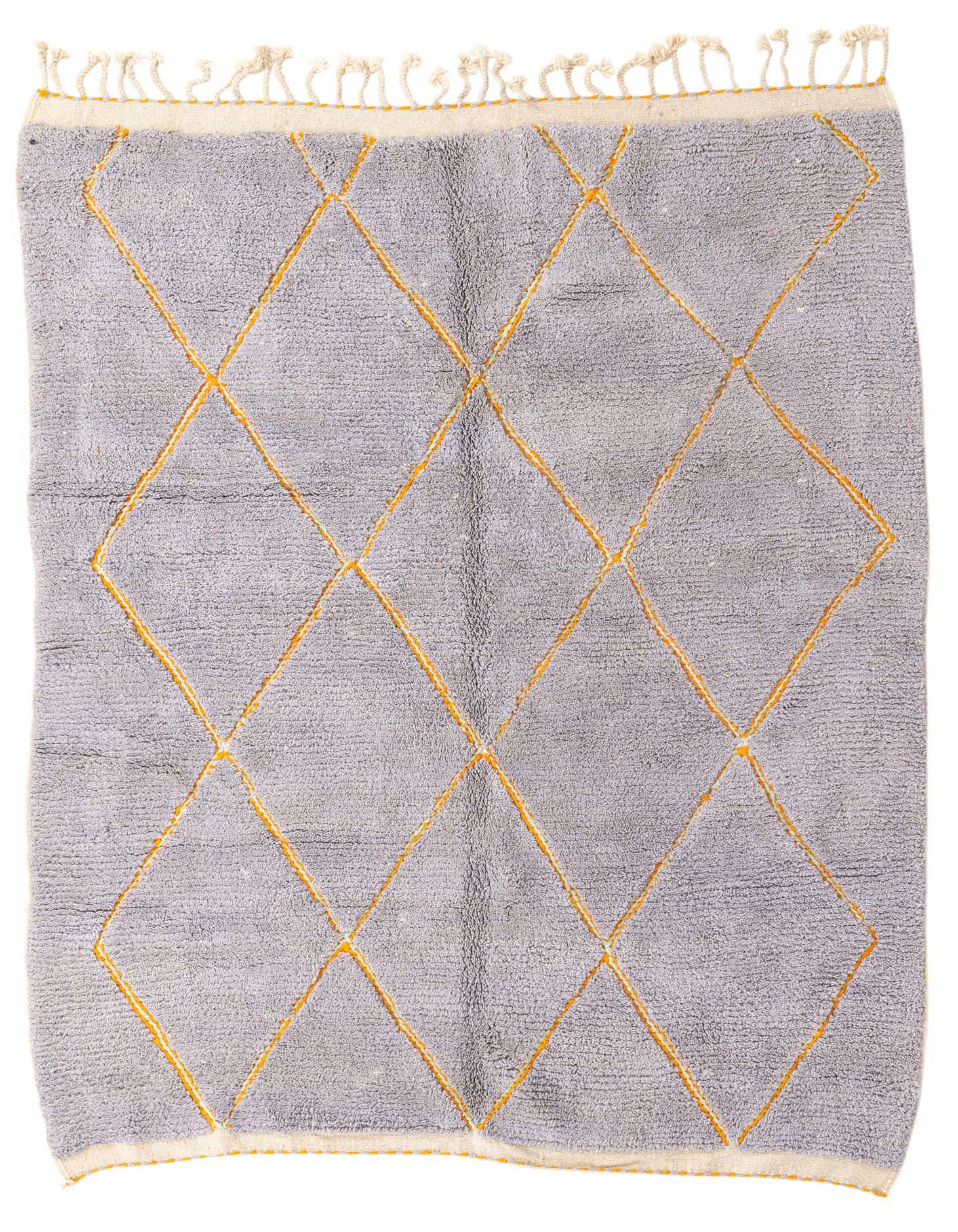 A 7x10 rectangular gray shag rug with a bold orange tribal diamond pattern and fringed ends.