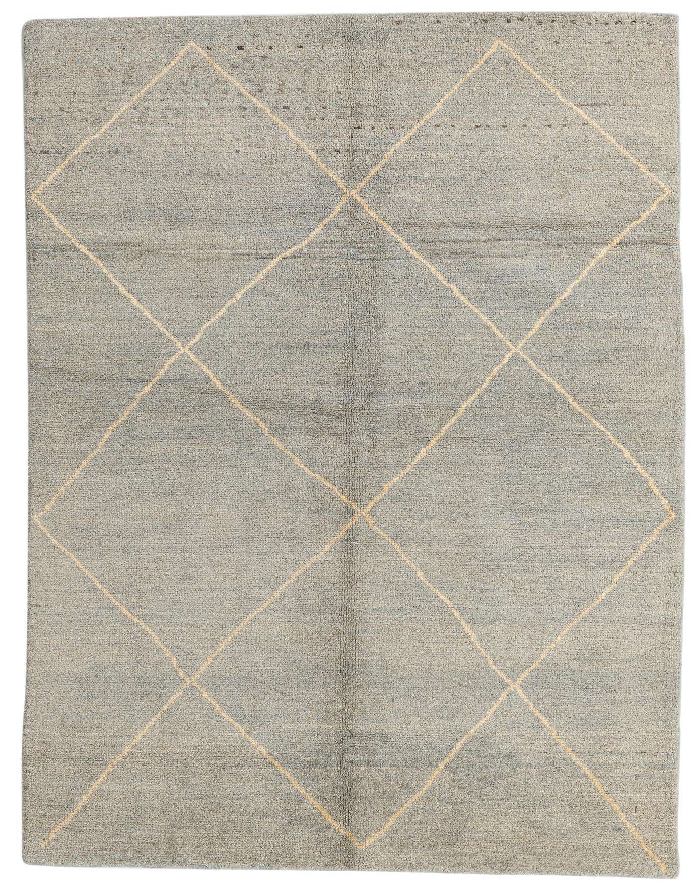 A 5x7 rectangular gray wool shag rug with a cream tribal diamond pattern, perfect for an indoor living space.