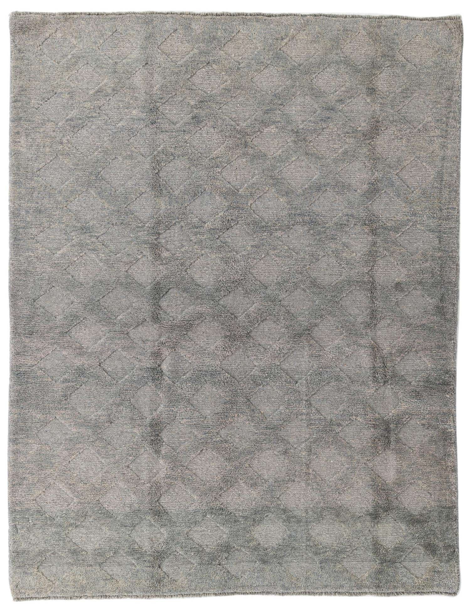 A 6x9 rectangular gray wool shag rug with a subtle tribal diamond pattern, ideal for a living room.