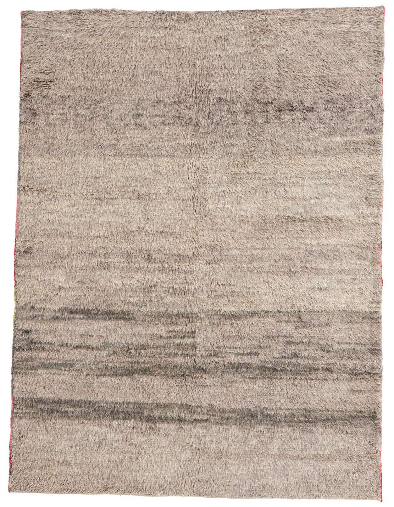 A 6x9 rectangular gray shag rug with subtle horizontal tribal patterns, handmade from wool, ideal for a living room.