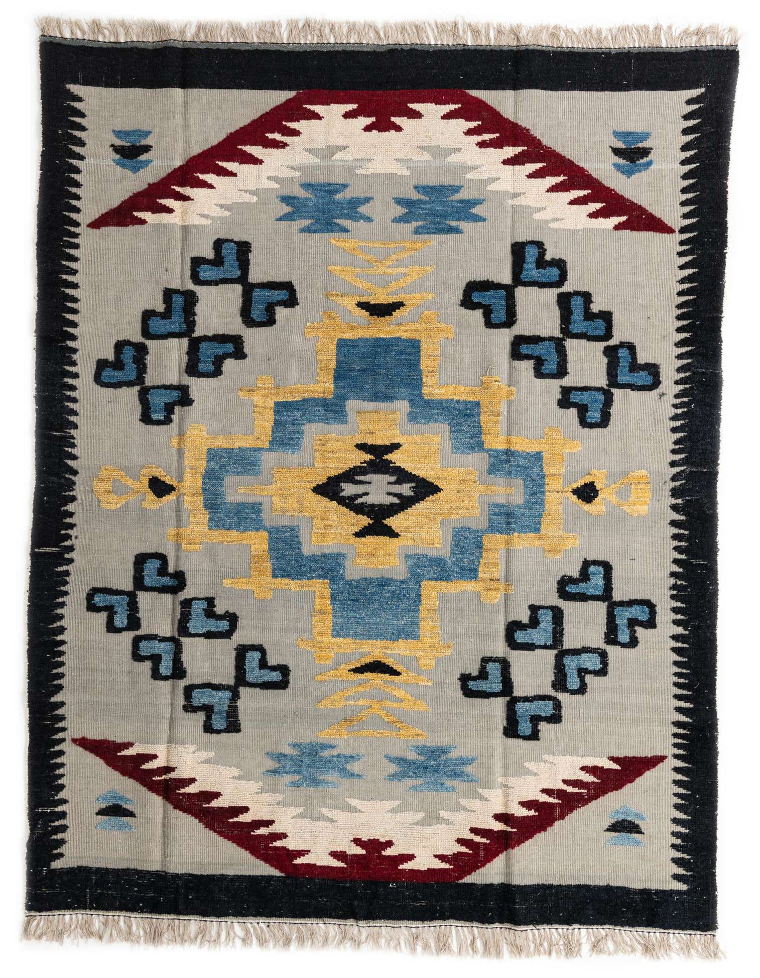 A 7x10 rectangular gray wool rug with a vibrant tribal medallion pattern in blue, gold, and maroon, featuring black borders and fringe.