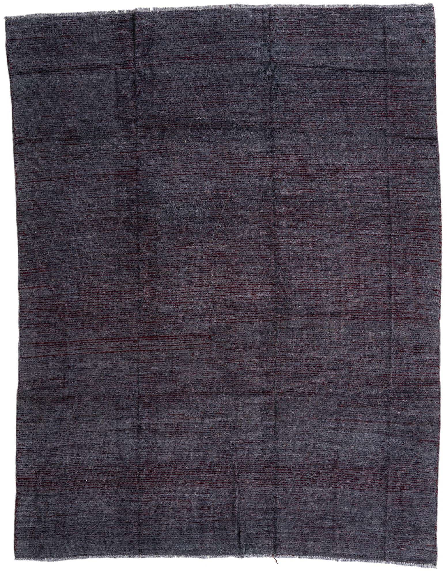 A rectangular 8x10 gray wool shag rug with subtle tribal patterns, suitable for a modern living room.