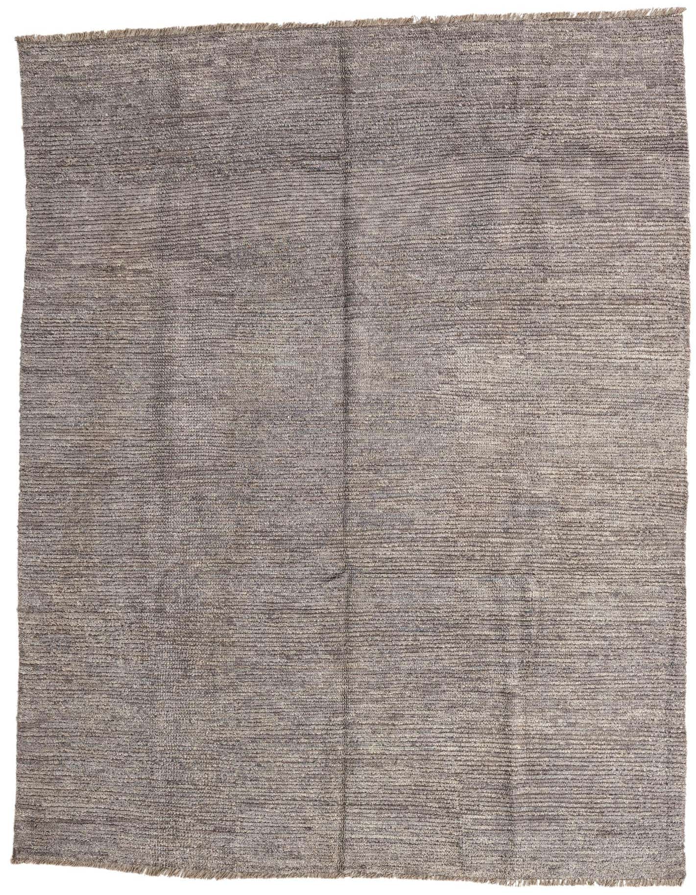 A 5x8 rectangular gray shag rug with a subtle tribal pattern, ideal for a modern living room.
