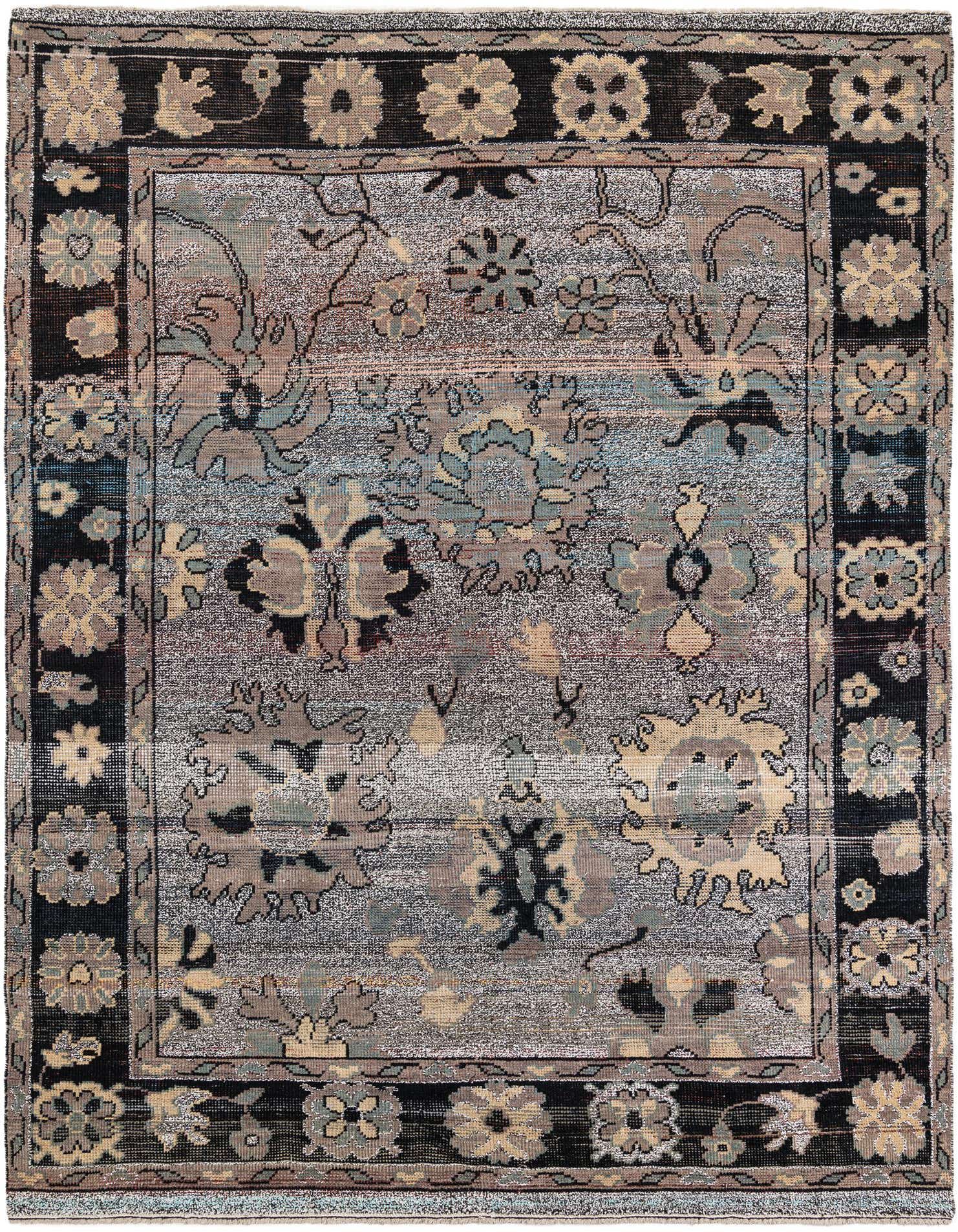 A 9x12 rectangular gray wool shag rug with a distressed tribal floral pattern and a dark border.