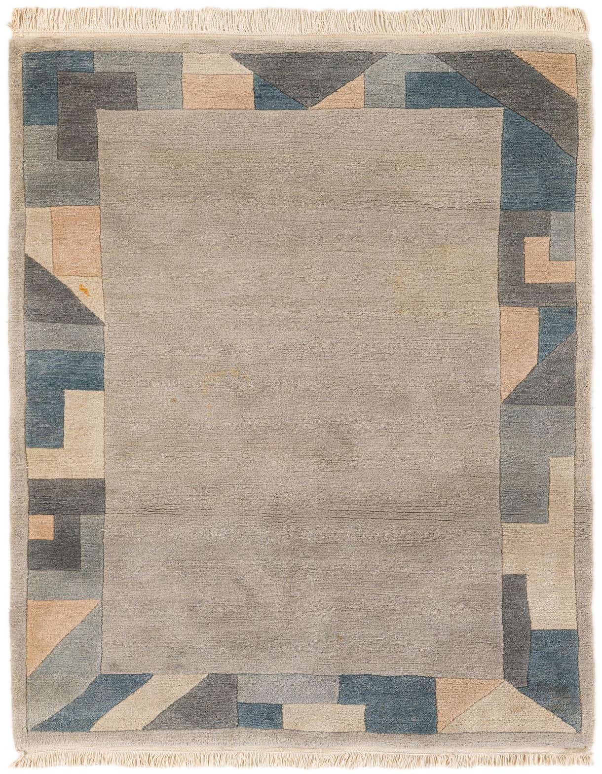 A 4x6 rectangular gray wool rug with a modern abstract border in shades of blue, gray, and peach, featuring geometric shapes and fringe.
