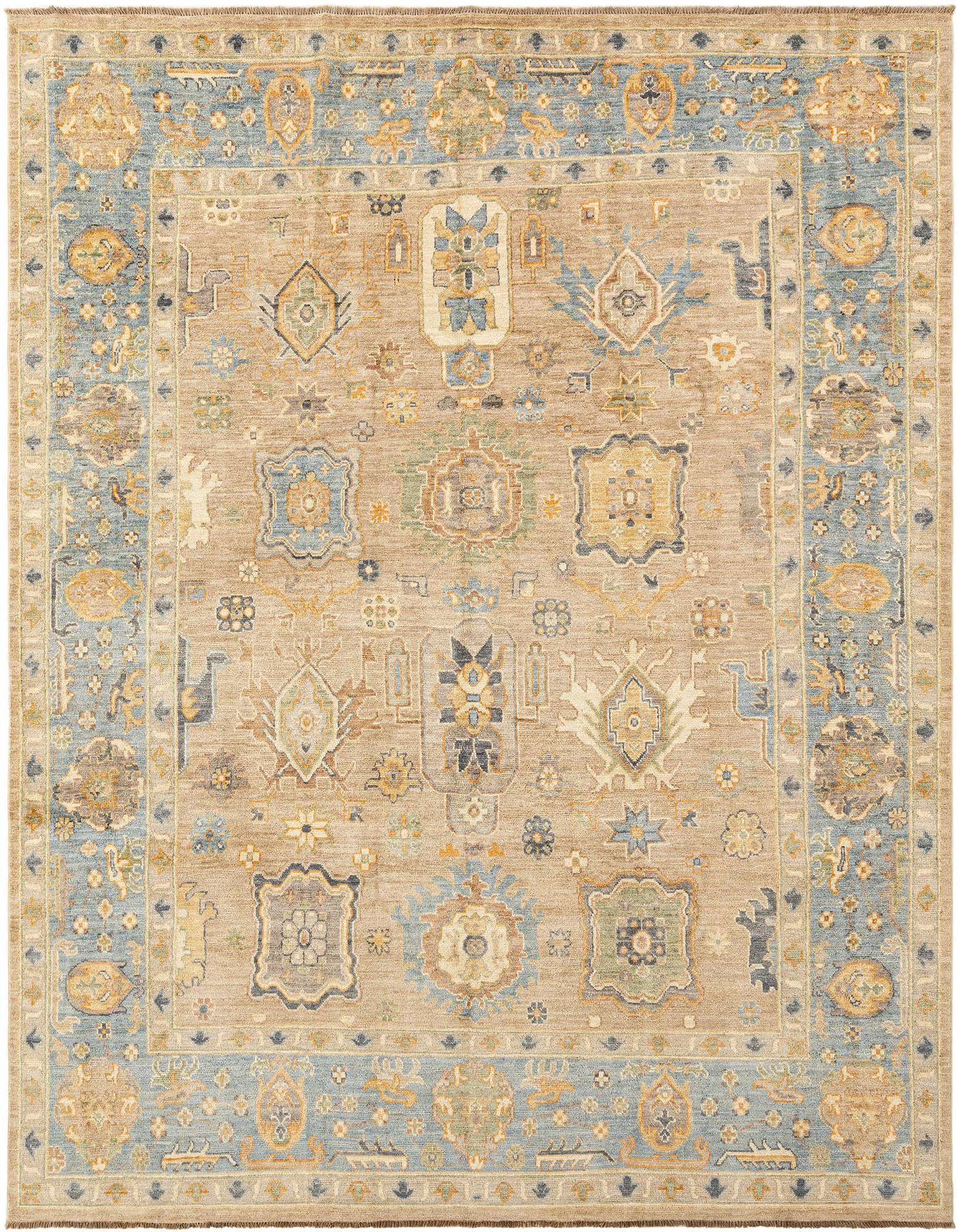 A handmade rectangular Oushak rug featuring a tan field with intricate Persian patterns in muted blues, grays, and golds, framed by a wide blue border.