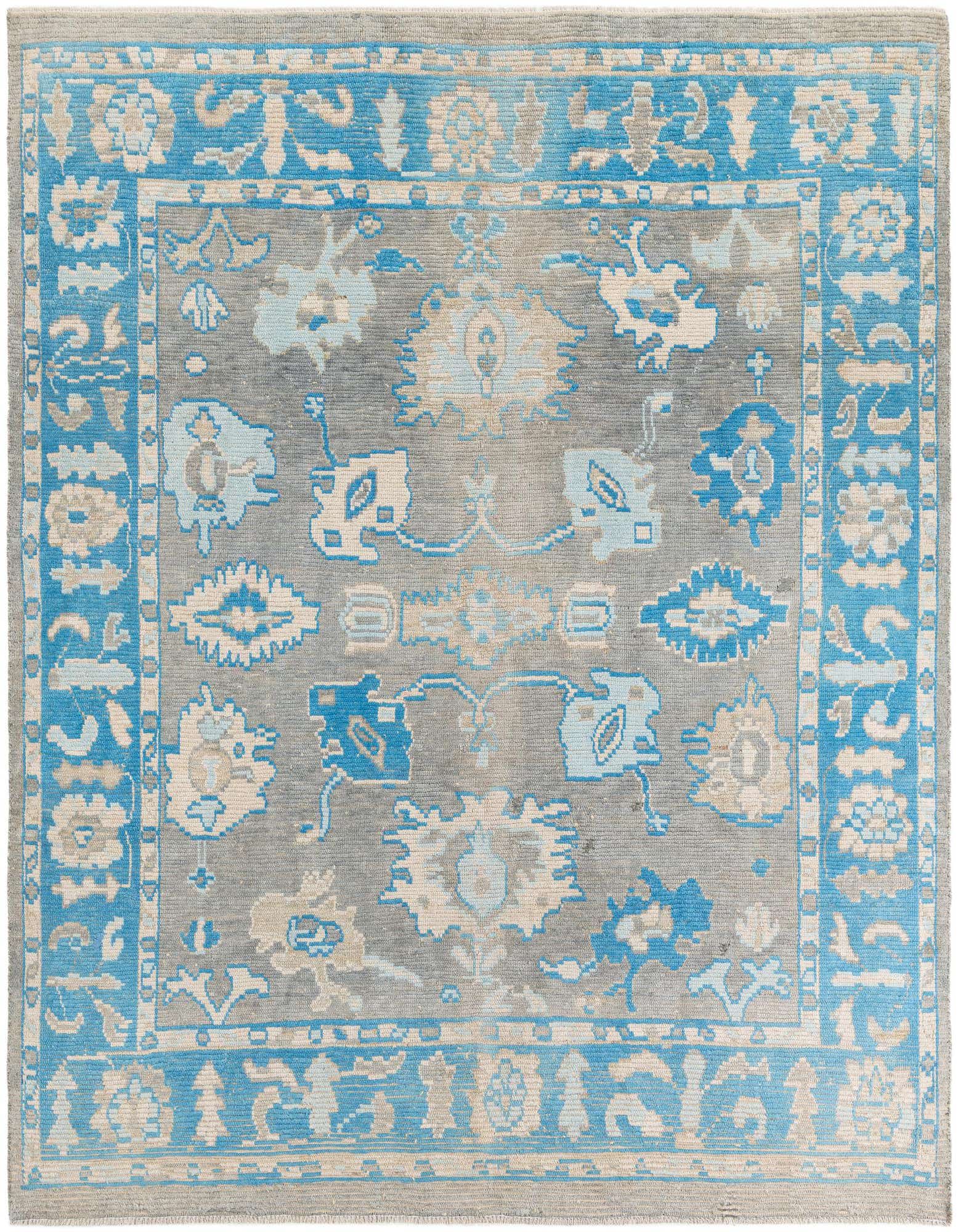 A rectangular 8x10 Rugs.com Oushak rug with a modern gray field and light blue and cream floral patterns, bordered by a vibrant blue and cream design.
