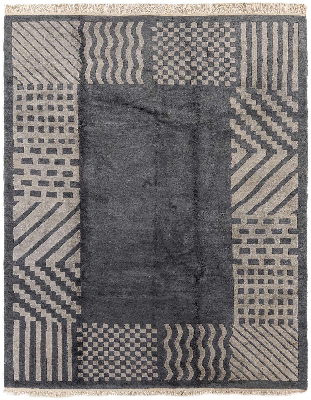 A 7x10 rectangular gray wool rug with a modern abstract pattern featuring various geometric shapes and wavy lines in lighter gray.