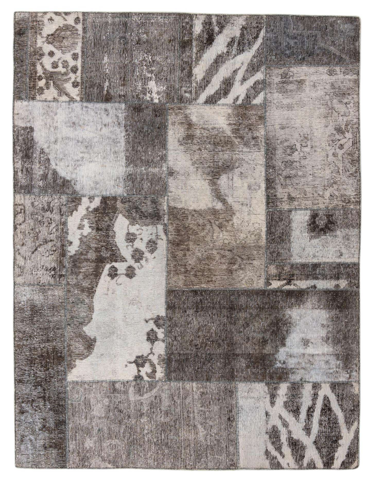 A 6x9 rectangular Ultra Vintage wool rug featuring a patchwork design in various shades of gray and silver, blending Persian, modern, and abstract patterns.